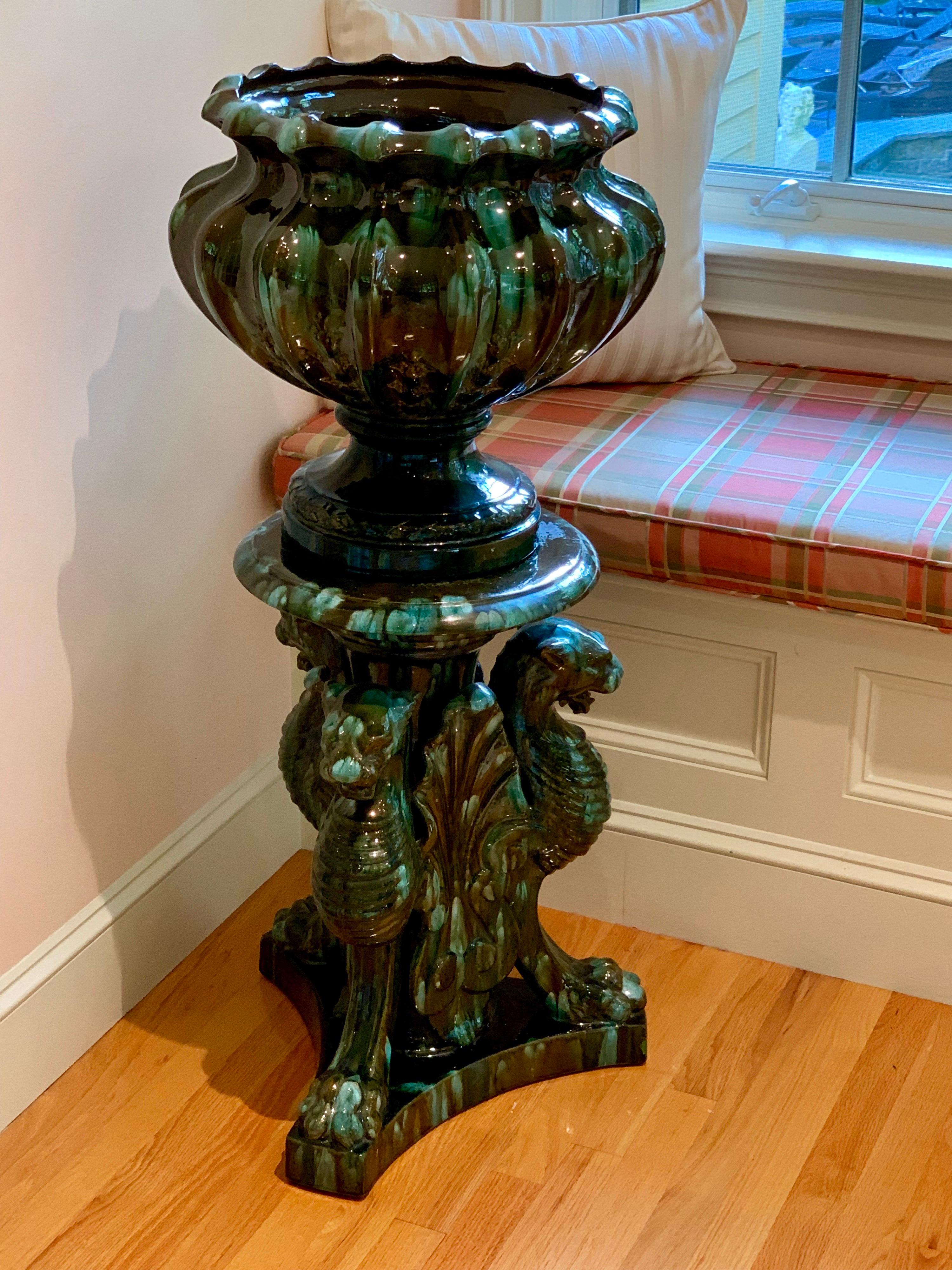 French neoclassical Majolica urn on stand by Clement Massier, circa 1890.
The Tripod like base has 3 stylized lions, the green/blue hues of this vase are magical as the light hits them, changing the color depending on the reflection.
 