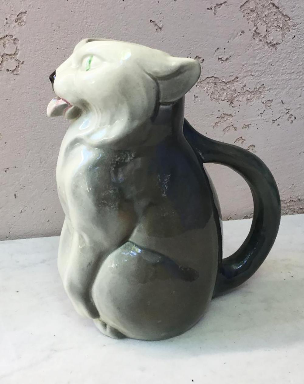 Amusing Majolica pitcher with a grey cat who put out the tongue signed Esdeve Sarreguemines Esdeve, circa 1930.