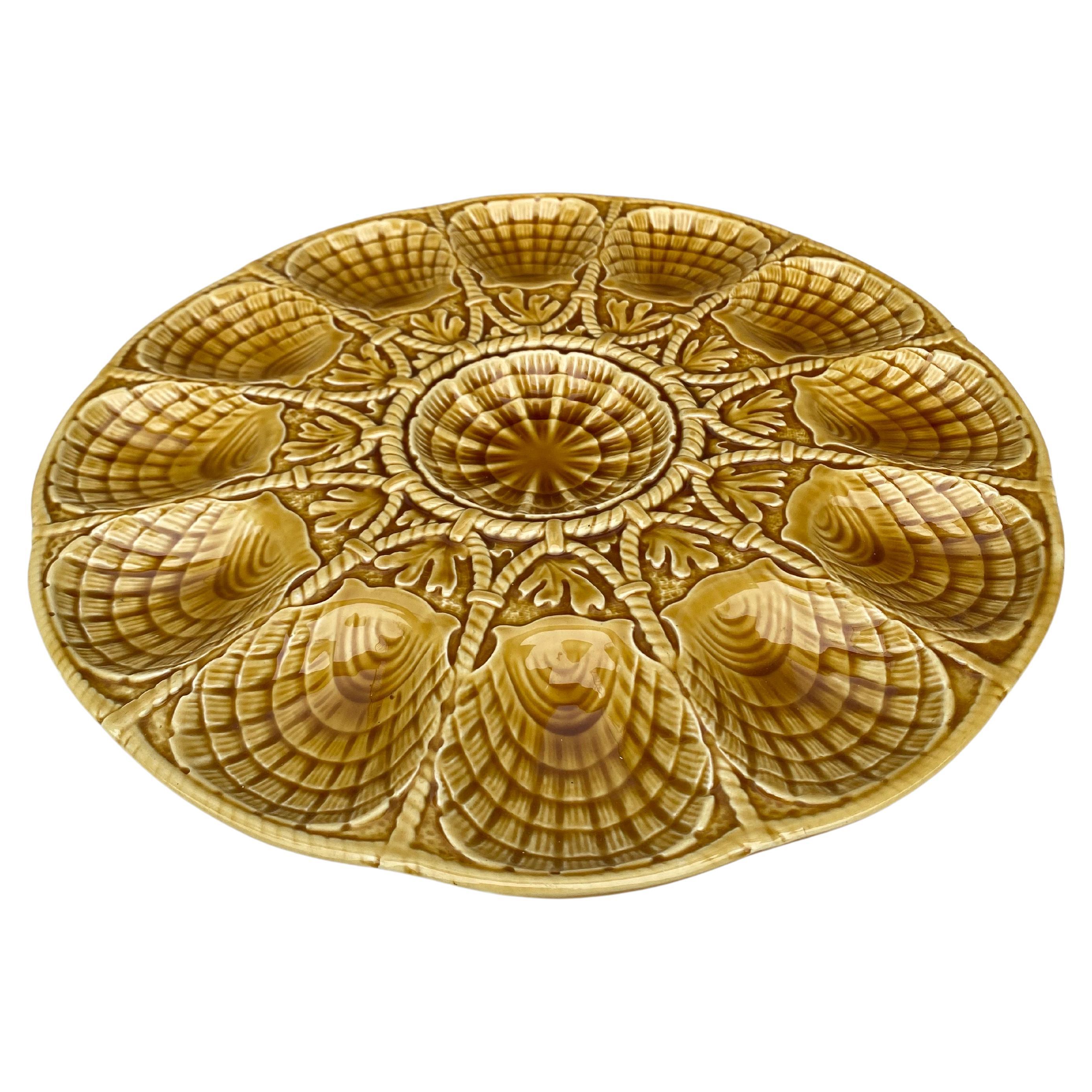 Majolica Yellow Shell Oyster Platter Sarreguemines Circa 1930.
The platter have 12 shells between rope pattern and seaweeds.
    