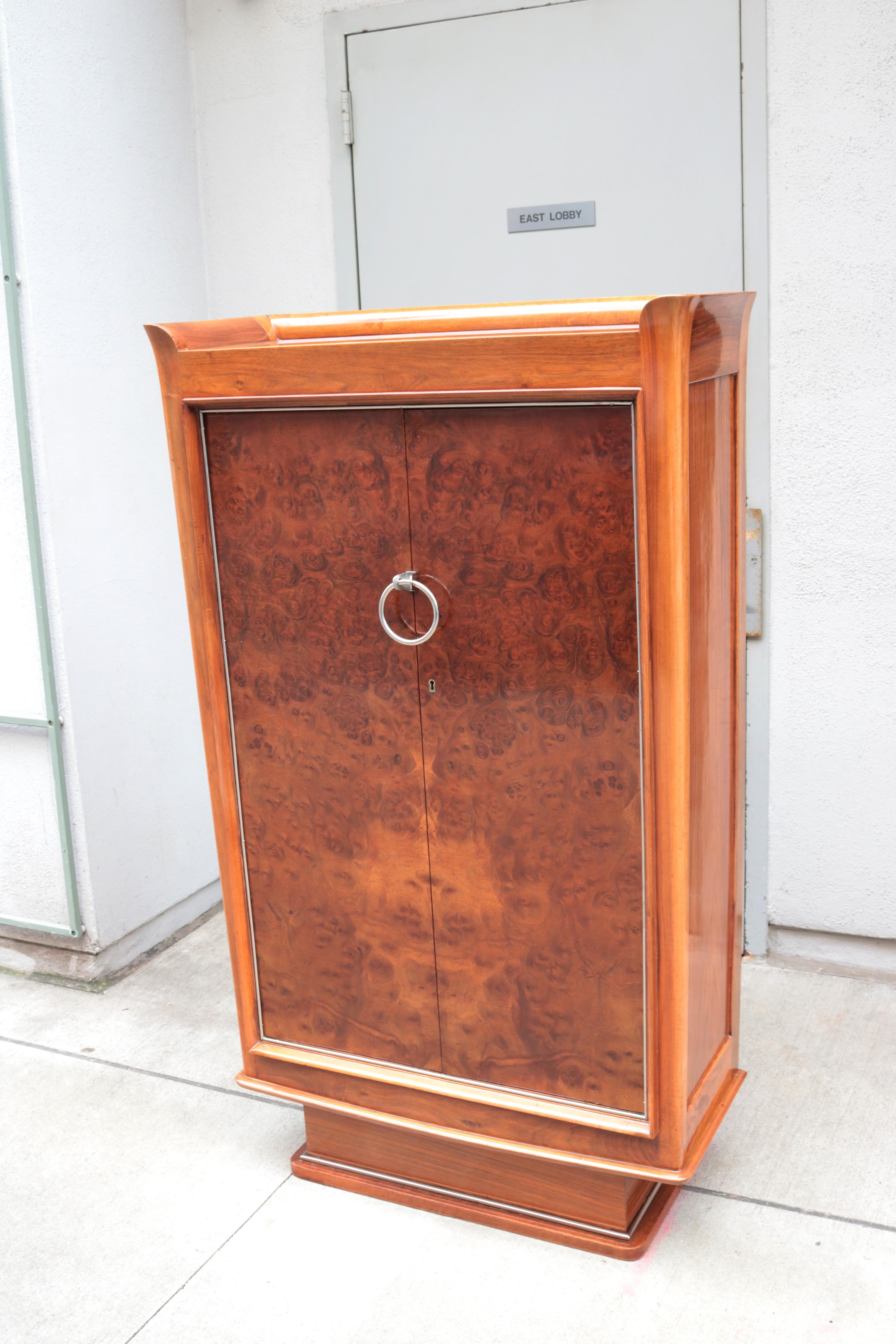 A fine Majorelle designed Art Deco tall two door cabinet. 
Walnut and walnut burl with nickeled details. 
Stamped on the back Majorelle.