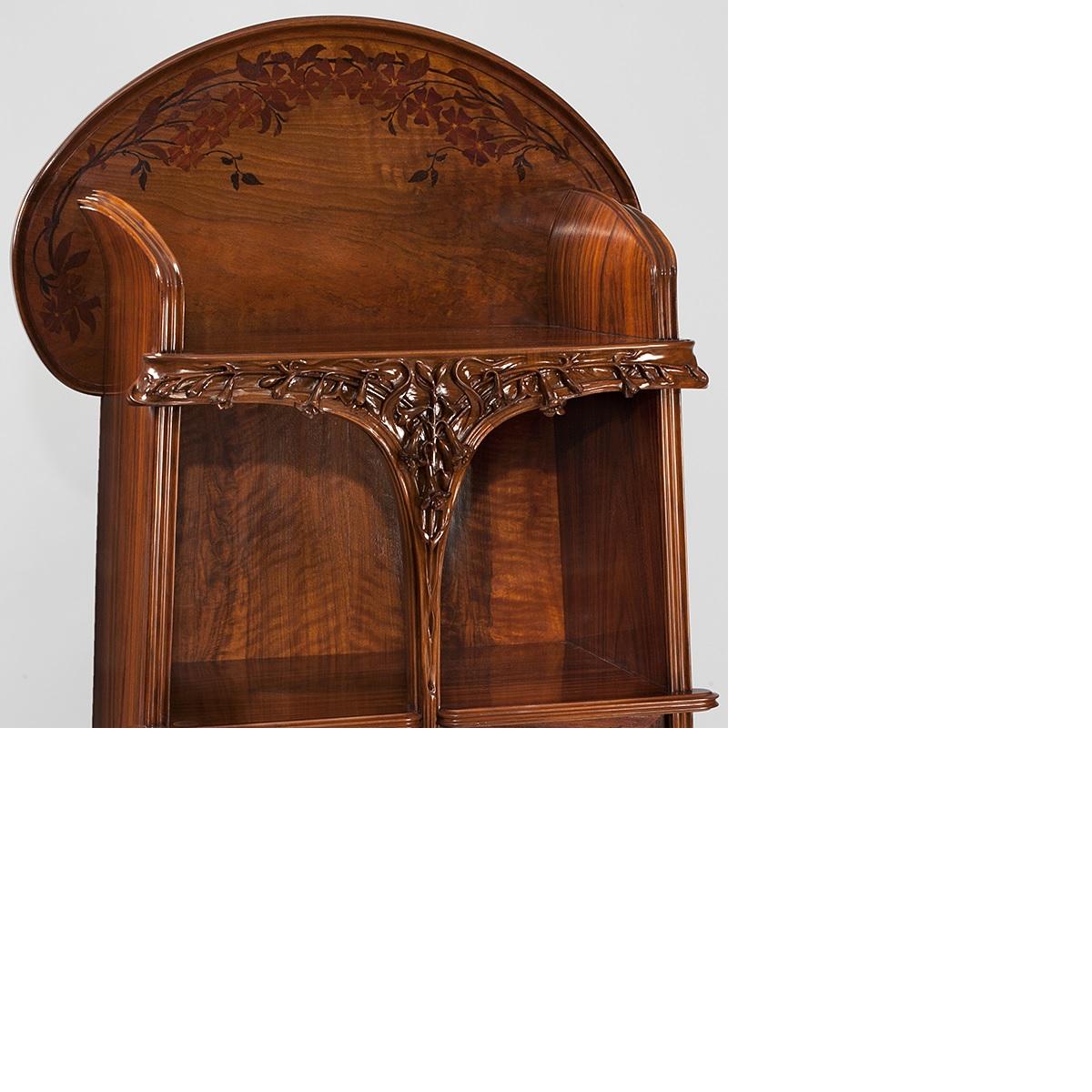 A French Art Nouveau two-door étagère or cabinet with two display areas by Louis Majorelle, featuring extravagant floral woodcarving and flora inlays. The piece also has two lockable cabinet spaces, each with two shelves, circa 1900s.

A similar