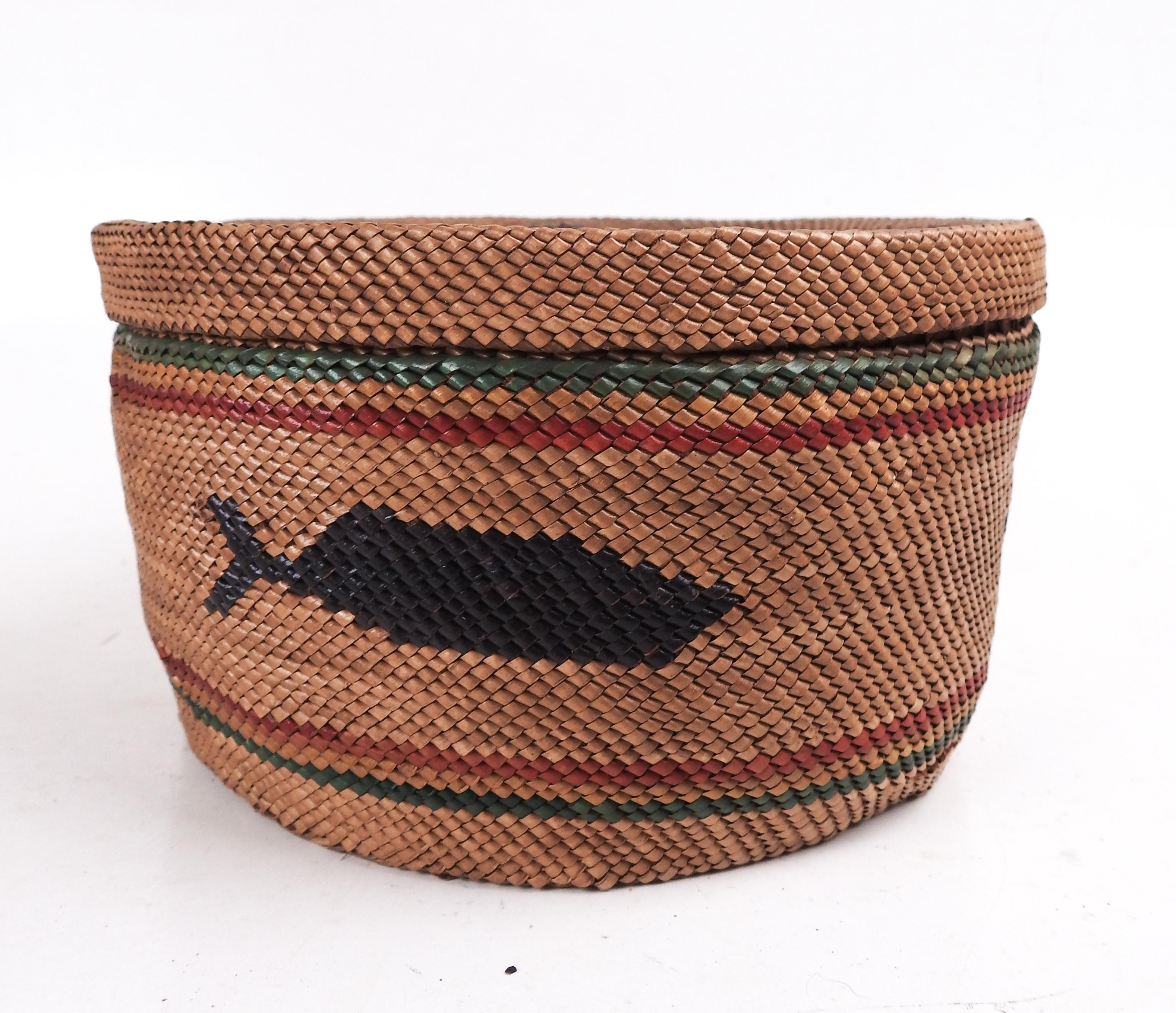 Early 20th century finely woven Makah or Nuu-chah-nulth Indian Basket.  One whale, 2 canoes with 3 and 4 hunters around body, ducks on lid, green and red banding, dark brown knob.  The Nuu-chah-nulth inhabit the west coast of Vancouver Island, the