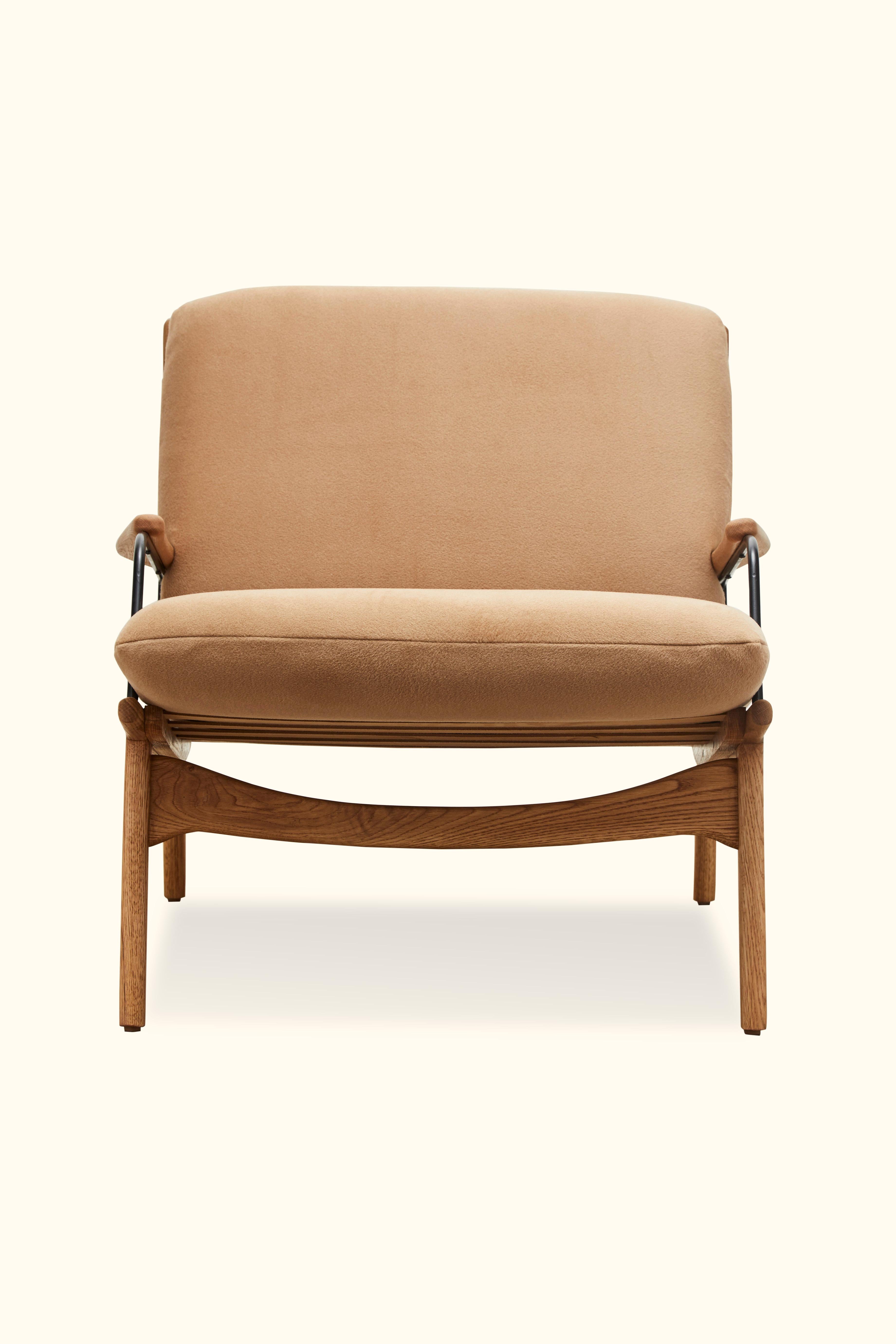 The Maker’s armchair is a solid walnut or oak frame chair with a leather sling that features brass details on the seat and back. Loose seat and back cushions are included.

Available to order in customer's own materials.