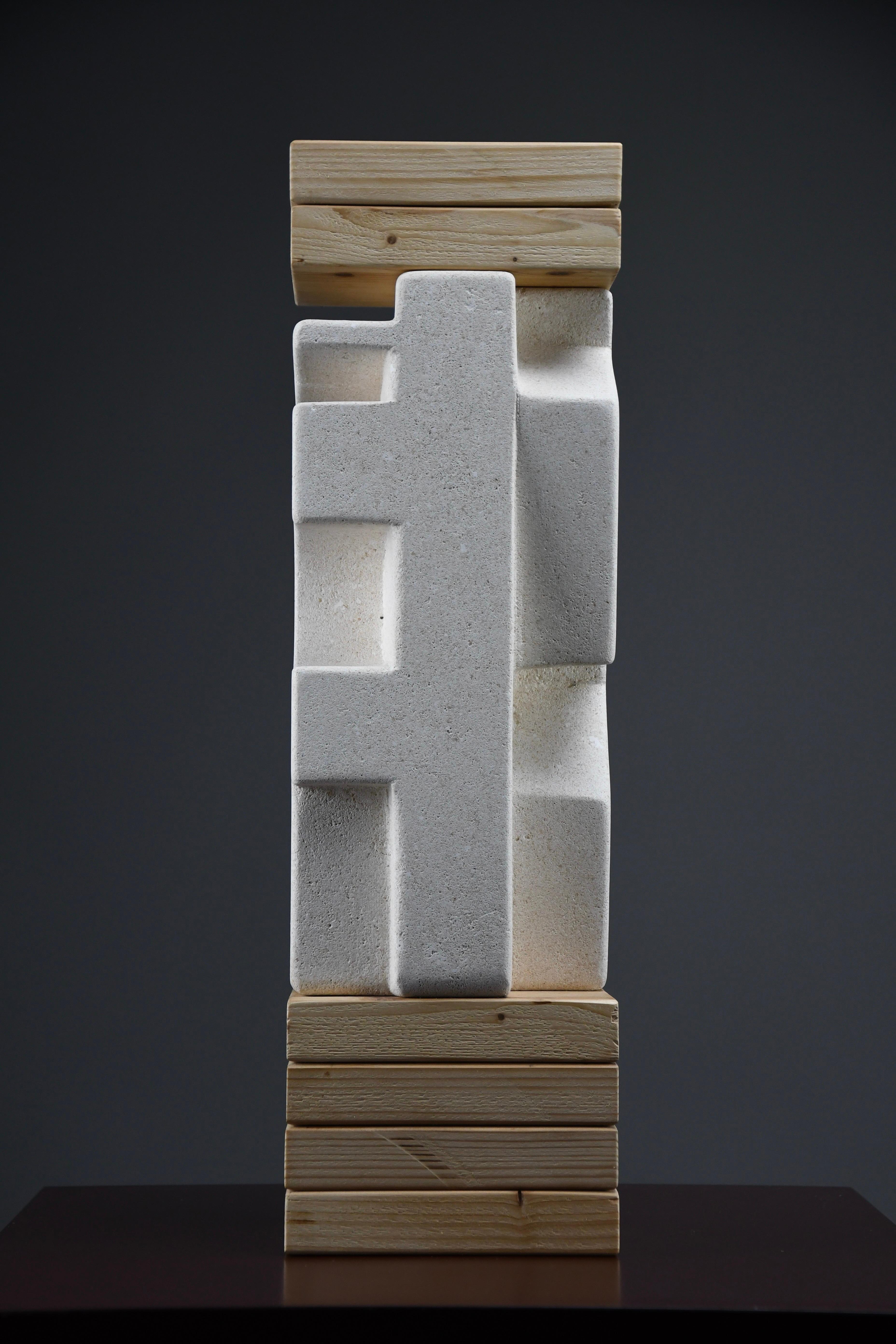 A Dialogue Between Form and Function

“Makina” is a powerful, architectonic sculpture by Alberto Cabiddu, created in 2001 from Pietra di Vicenza, a historic Italian limestone, and stacked wood elements. Evoking the language of machinery and