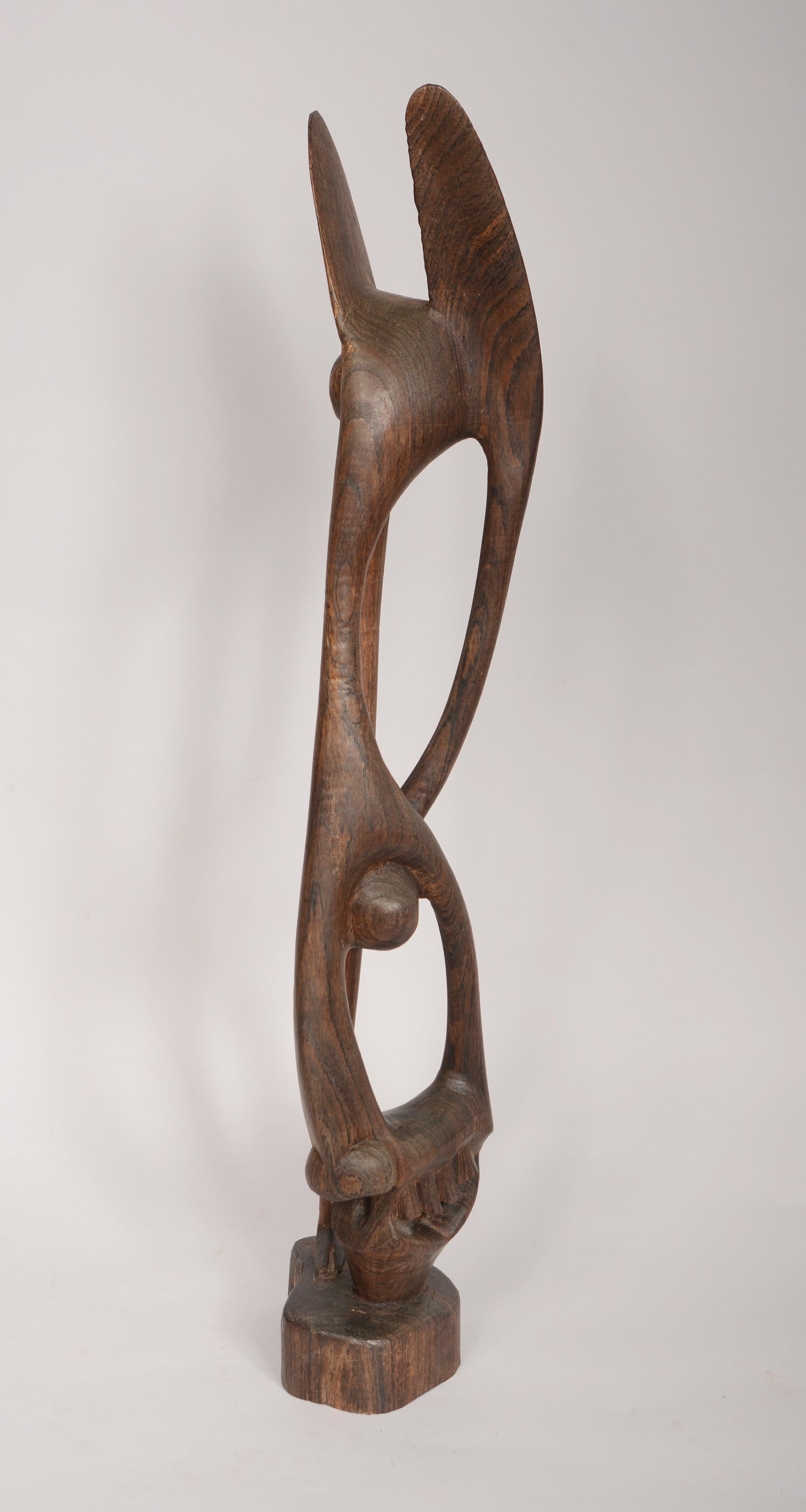 Carved hardwood Shetani sculpture by a member of the Makonde people of East Africa. These abstract sculptures came out of the influence of European and Western culture beginning in the 1930's. This sculpture is signed. This was collected in East