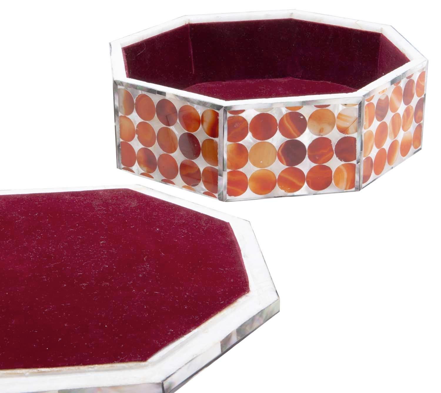 White Makrana marble, used to build the Taj Mahal, from Indian is the densest marble on the planet. This handmade octagonal shaped makrana marble box has rich abalone and carnelian inlay in orange and reddish tones. Plush red velvet lines the