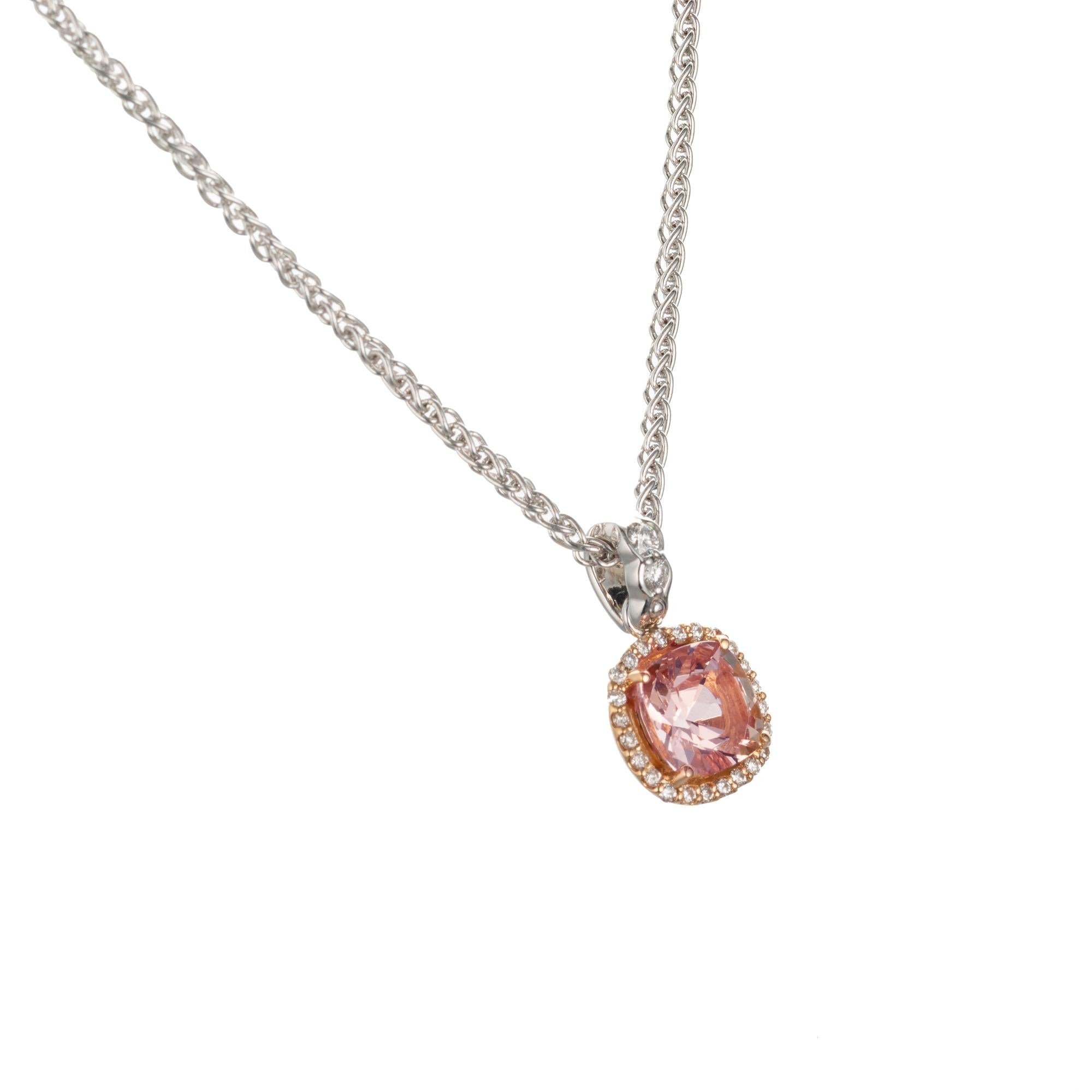 Makur morganite and diamond pendant necklace. 18k white and rose gold with center morganite and a halo of brilliant cut diamonds on a 18k white gold wheat link chain.

1 cushion soft pink morganite beryl, Approximate 1.30ct
26 round brilliant cut