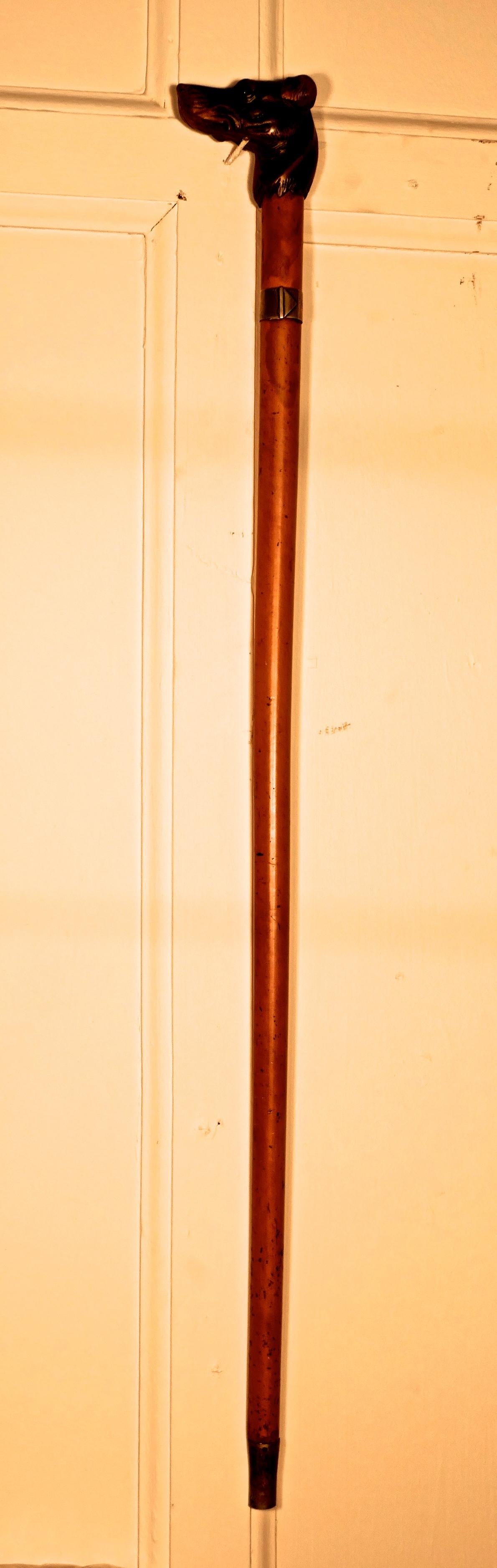 Malacca cane with carved dog head and silver collar

A good malacca walking stick with a superbly carved pommel in the form of an elegant Retriever Dog’s Head with glass eyes
Beneath the head there is a wide silver buckled dog collar with W.W