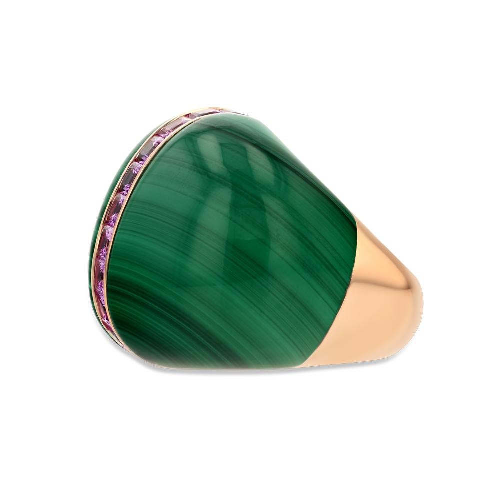 Composed of malachite, 18 karat rose gold, and 11 pink sapphire stones, this bubble ring is an eccentric statement piece that is sure to turn heads. Not only do the colors come together to create a bright lively vision, but upon further glance one