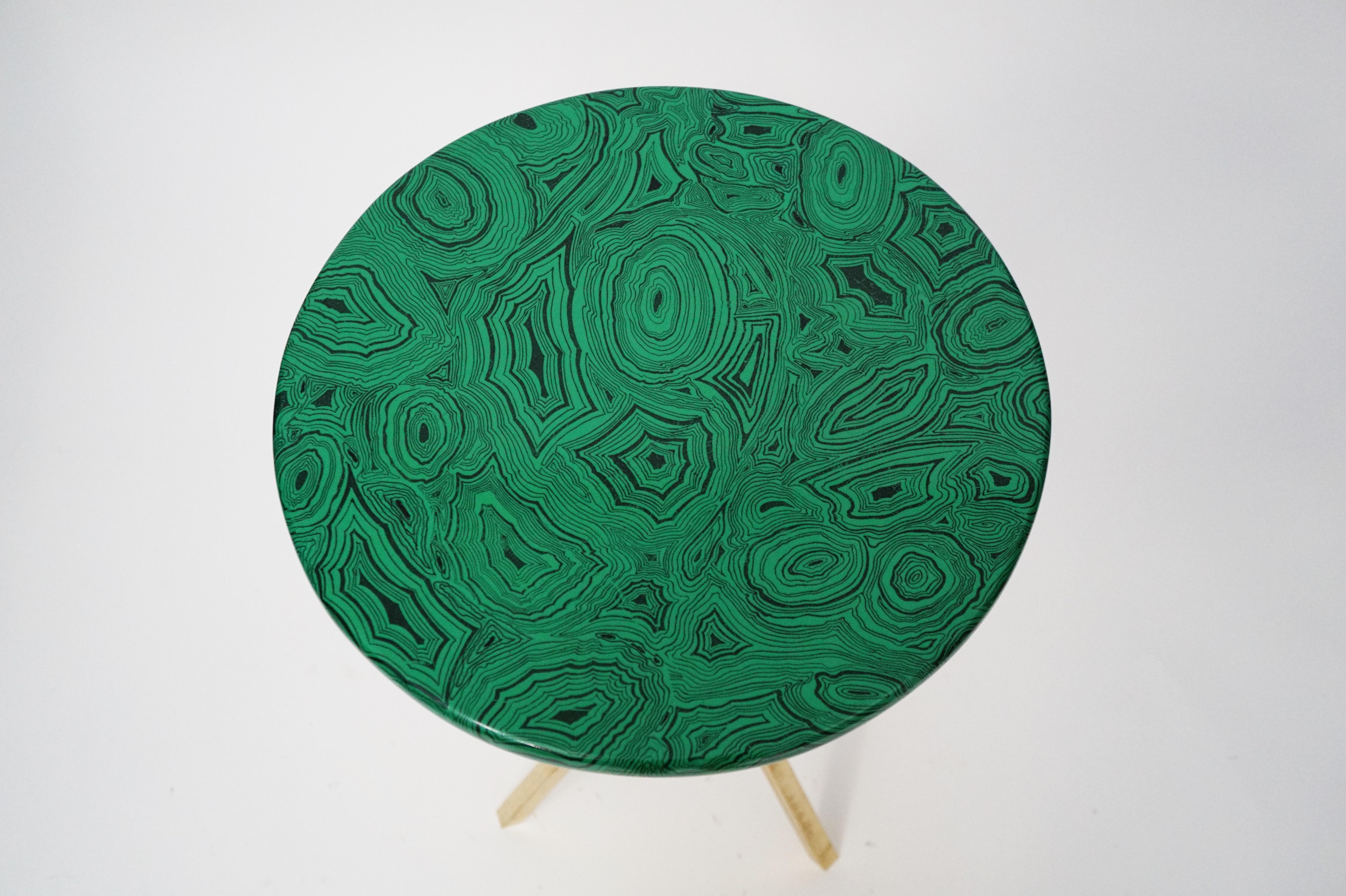 This gorgeous collectors item is a 'Malachite' side table by Piero Fornasetti, signed underneath with its original label. The side table is made with lacquered wood that has a malachite motif and is affixed on top of a brass tri-pod base that is