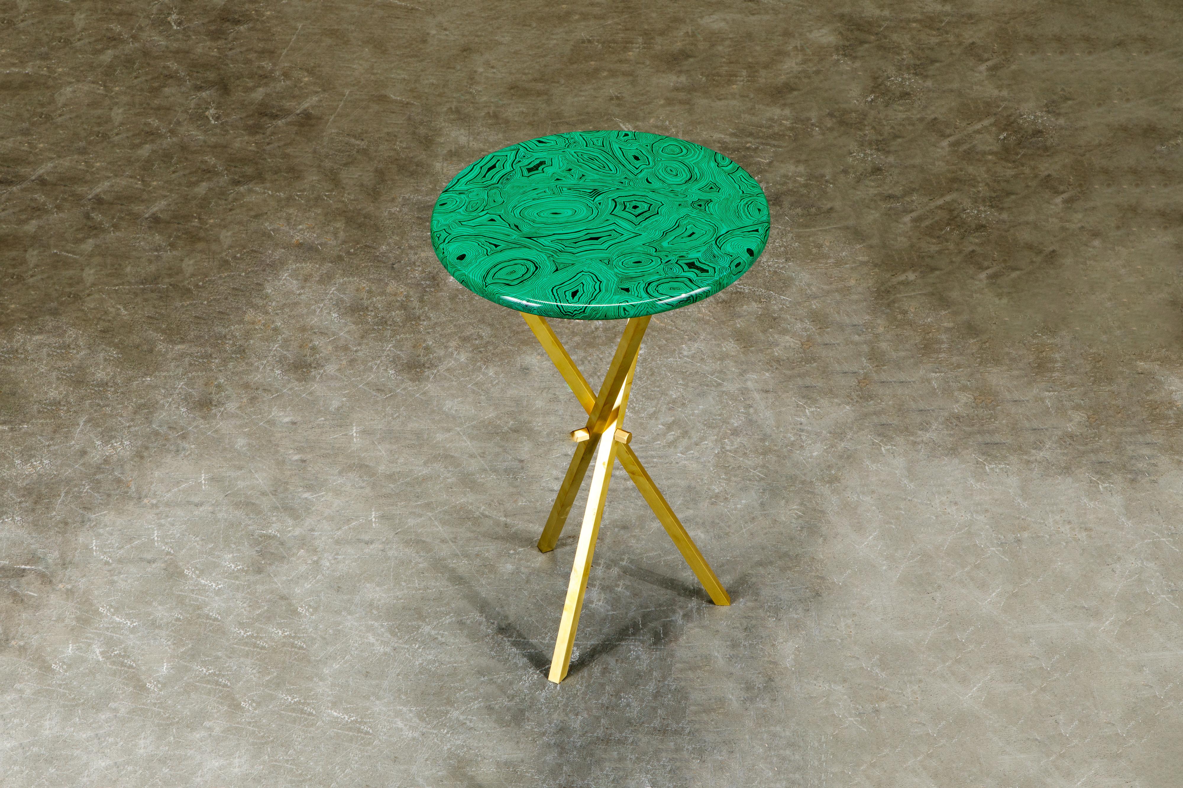 This gorgeous collectors item is a 'Malachite' side table by Piero Fornasetti, signed underneath with its original label. The side table is made with lacquered wood that has a malachite motif and is affixed on top of a brass tri-pod base that is