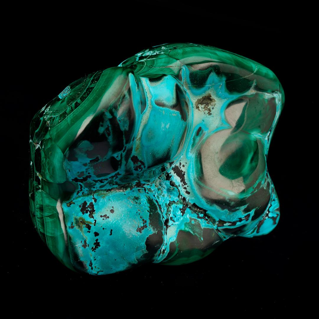 This whimsically shaped freeform features naturally co-occuring malachite and chrysocolla swirled together in an energetic tableau. Hand-polished to perfection, malachite bullseyes are set naturally against the deeply pigmented, unmistakable