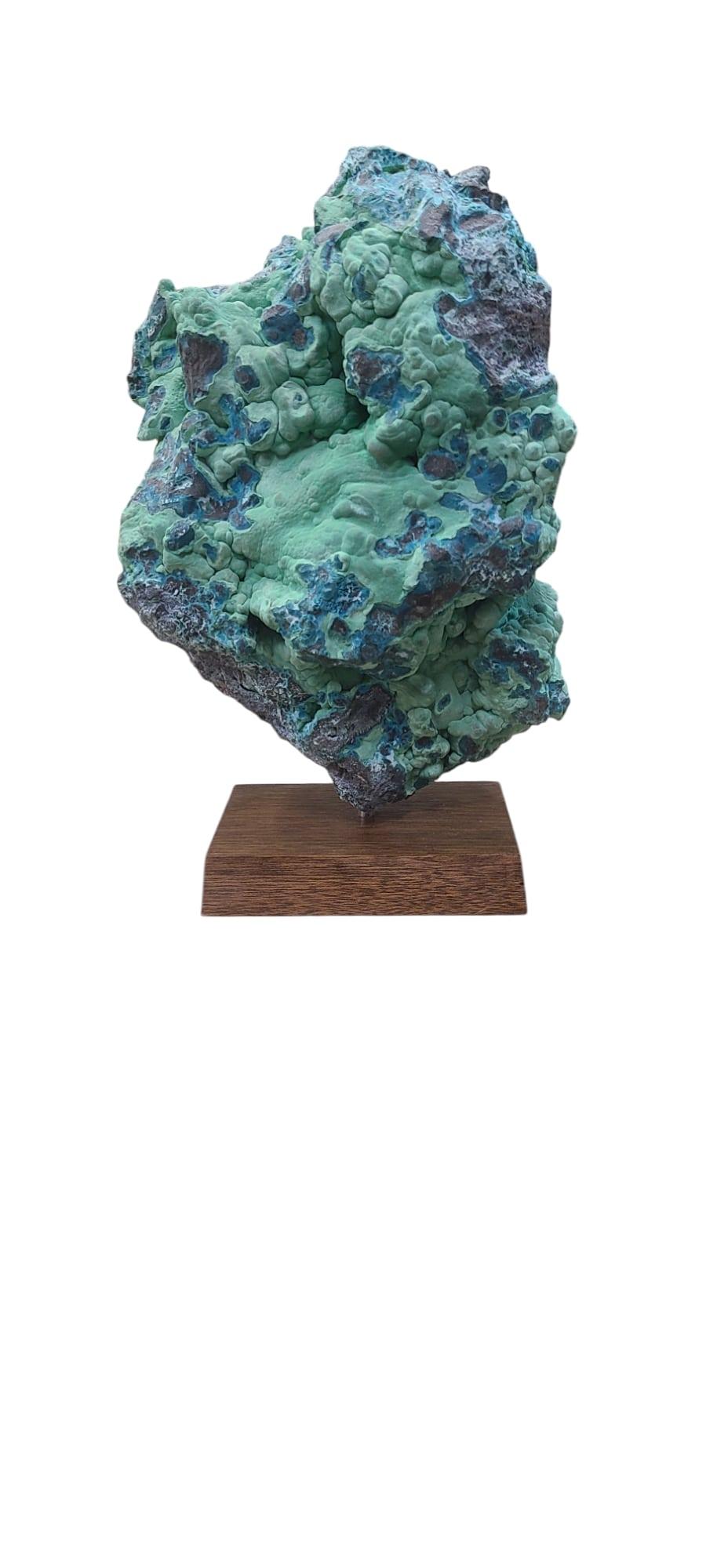 This mineral specimen from Congo, mix of malachite and chrysocolla, is deviated from copper. 
Showing a smooth and hilly surface of green malachite and deep vibrant blue color chrysocolla.

The piece is mounted on a wooden stand, linked by a steel