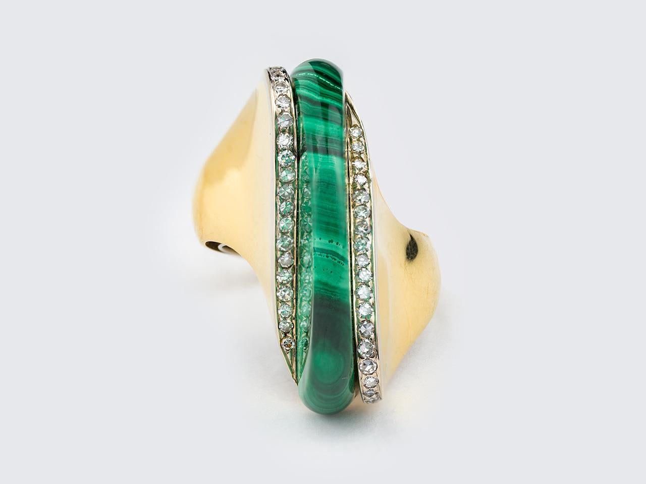 18kt gold Modernist ring, centering a fine cut Malachite stone, with diamond accents. 18kt.
