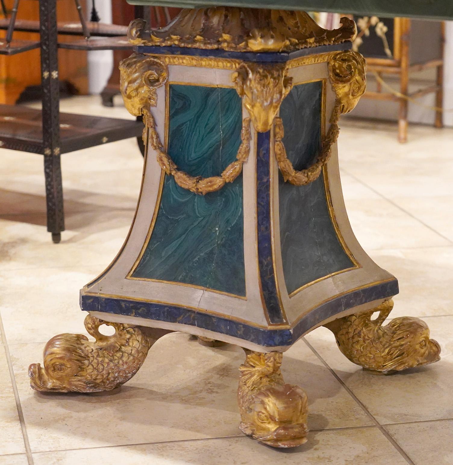 Measuring 36 x 102 inches this grand Italian dining table features a cast top clad with green Malachite centering a rectangular field of blue Lapis Lazuli. An intriguing color combination. The top rests on two 19th century baroque style pedestals