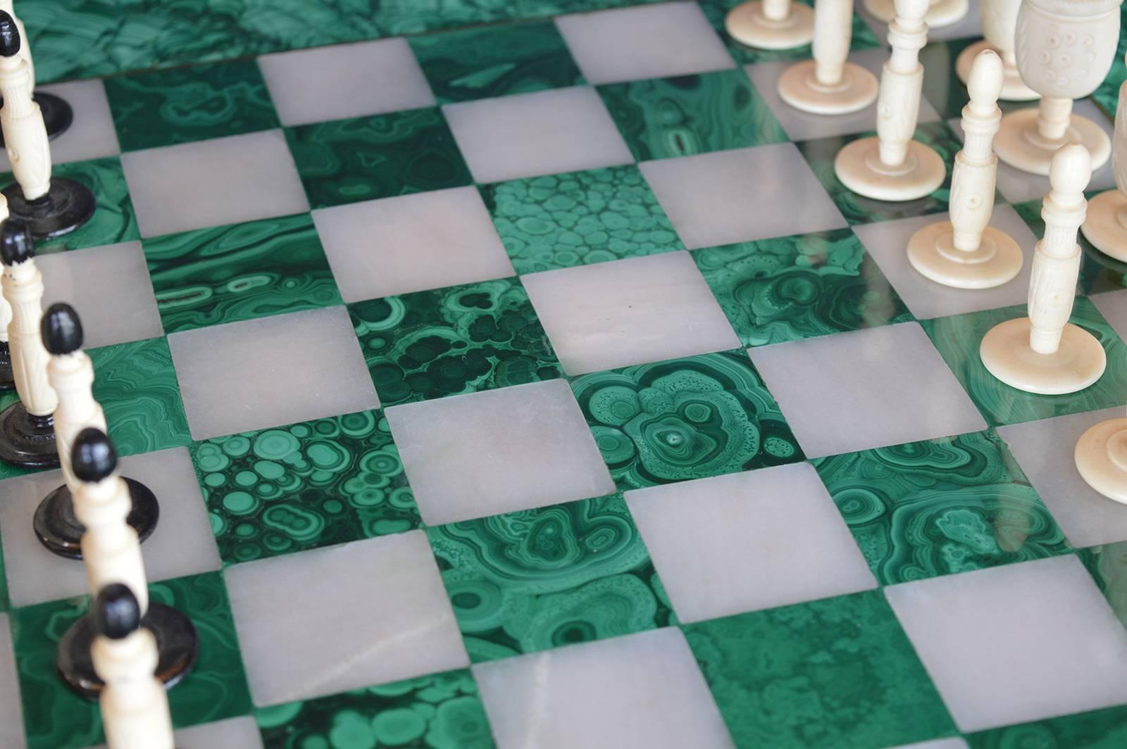 Malachite and marble chess board with hand-carved bone playing pieces. The board is from Africa and the pieces are Italian.