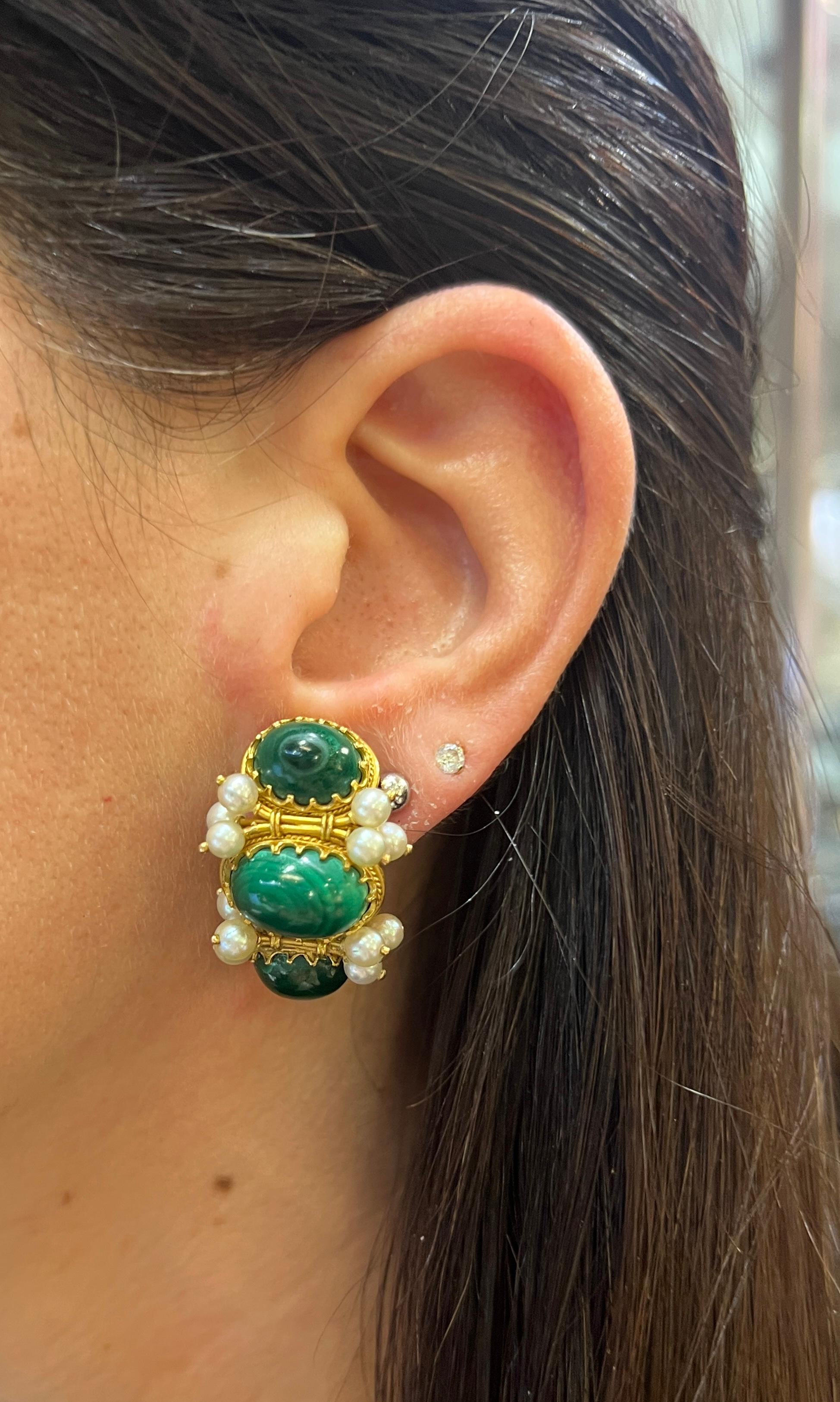 Malachite and Pearl Earrings 

A pair of yellow gold earrings set with 6 malachite stones and 24 pearls.

Approximate Length: 1 inch
Back Type: Clip on  
Metal Type: 14 karat gold 
