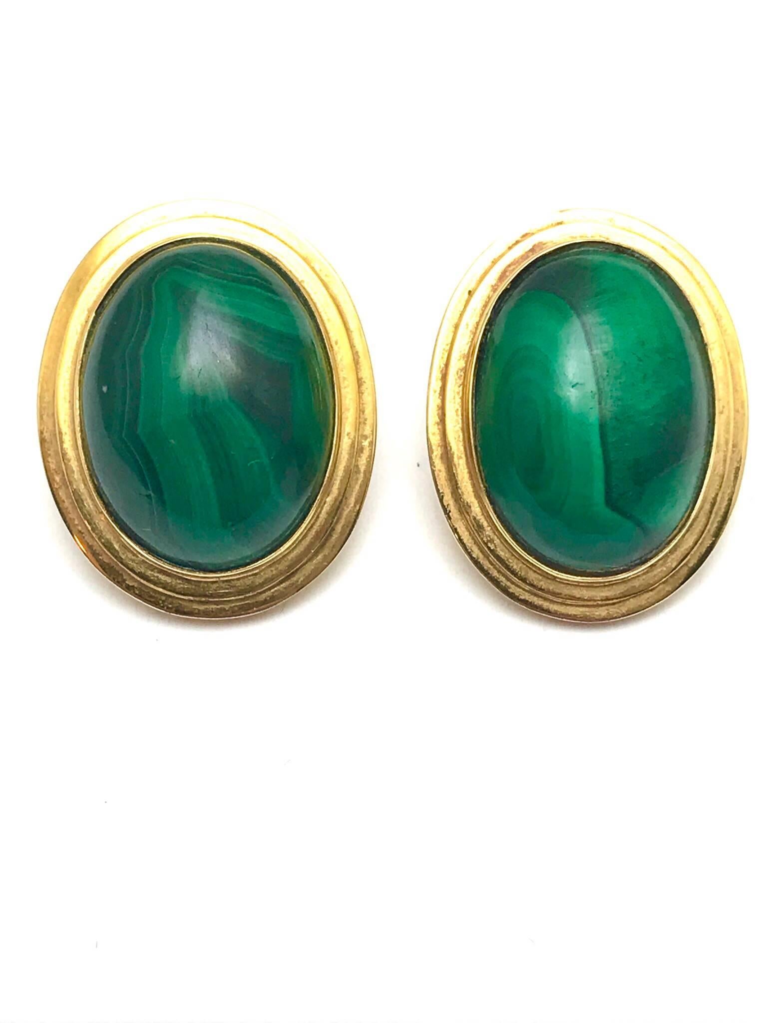 A pair of malachite and 14 karat yellow gold clip on earrings.  The malachite has a smooth domes finish, with a two tiered yellow gold frame and clip back.  (a post can be put on).

Hallmark:  14K