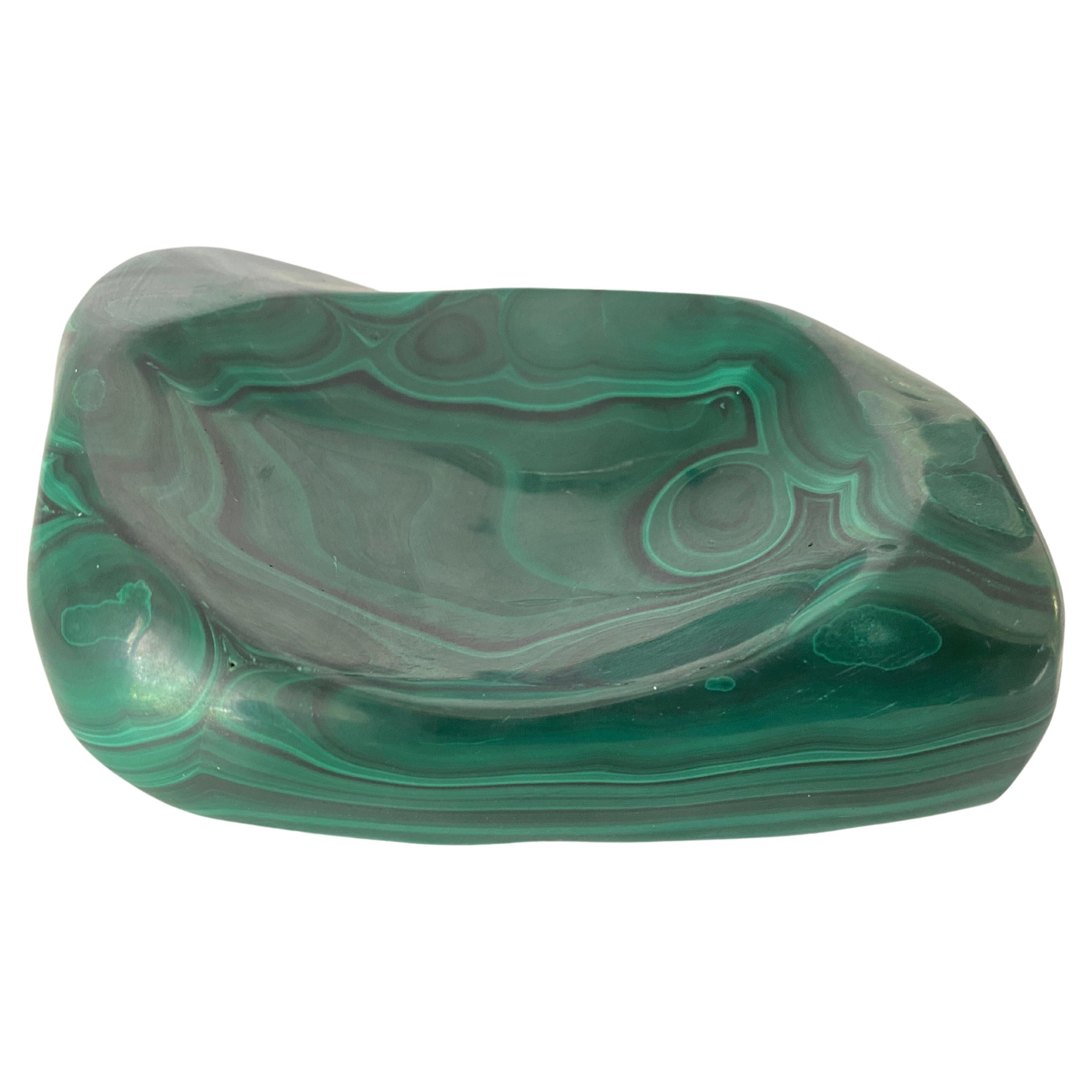 Great and unique shape carved malachite stone ashtray or vide poche. Imposing item, stunning color and pattern which makes it unique. Natural malachite sculpture. Some are called vide poche or ashtray dresser caddy or valet tray and sundries bowl.
