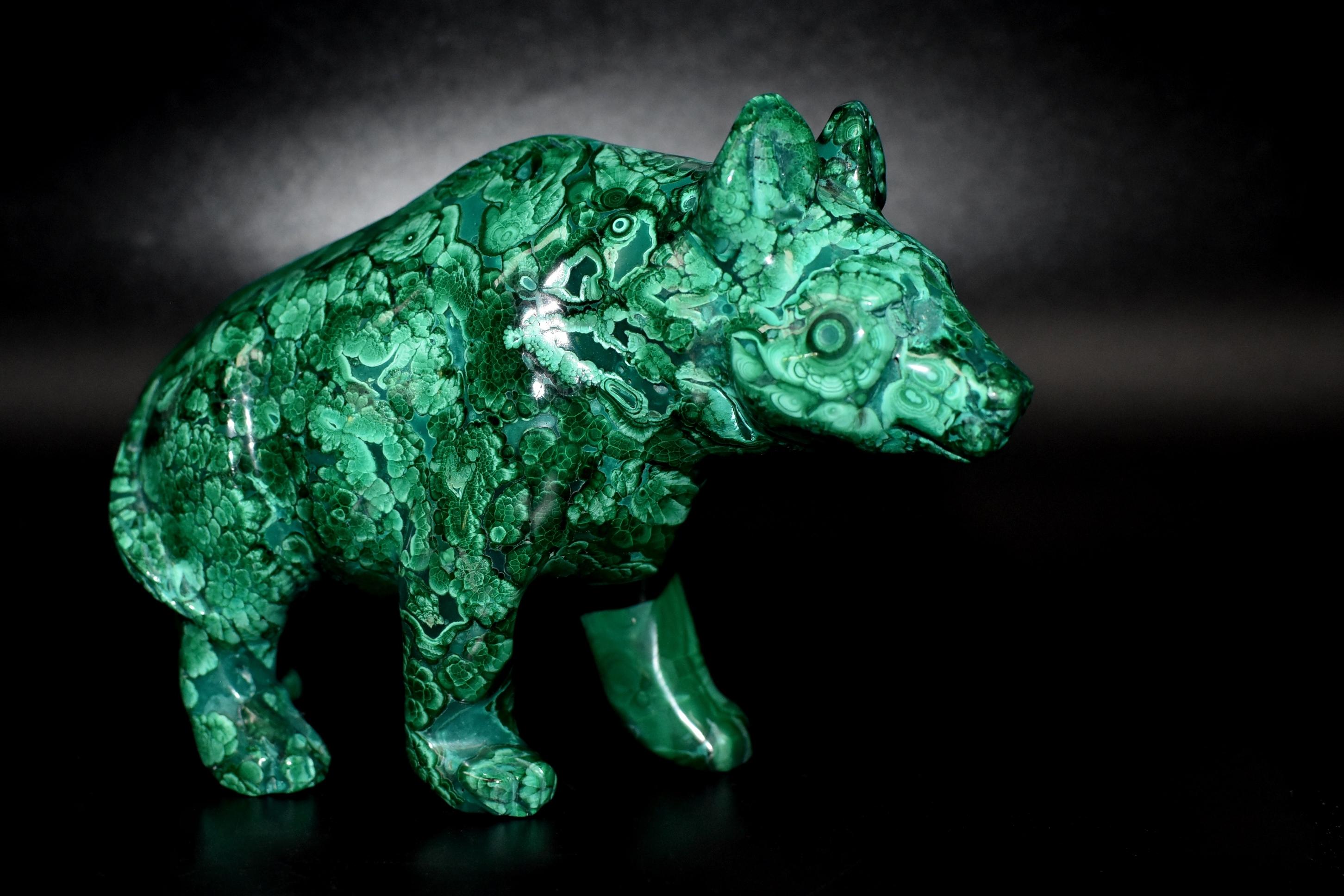 A wonderful 2 lb bear sculpture in the most spectacular natural malachite. The bear is depicted in walking motion. His eyes were perfect circles that were natural to the stone. All natural with splendid swirls and patterns, this remarkable pieces is