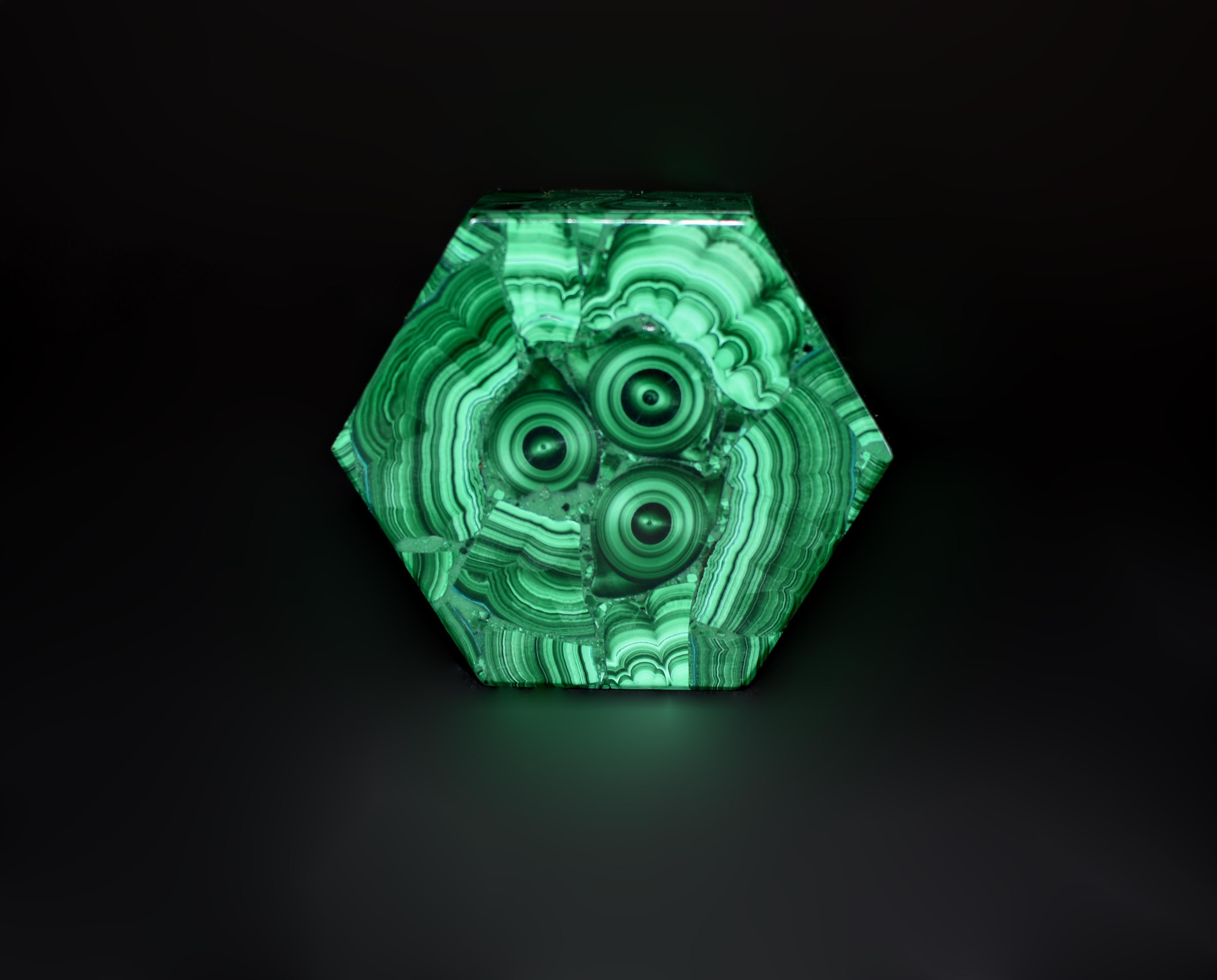 This fine-grade malachite hexagonal box showcases the rare and highly prized bull's eye pattern. Malachite, with its captivating range from light to dark green, is most sought after when displaying concentric rings and swirls, with the bull's eye