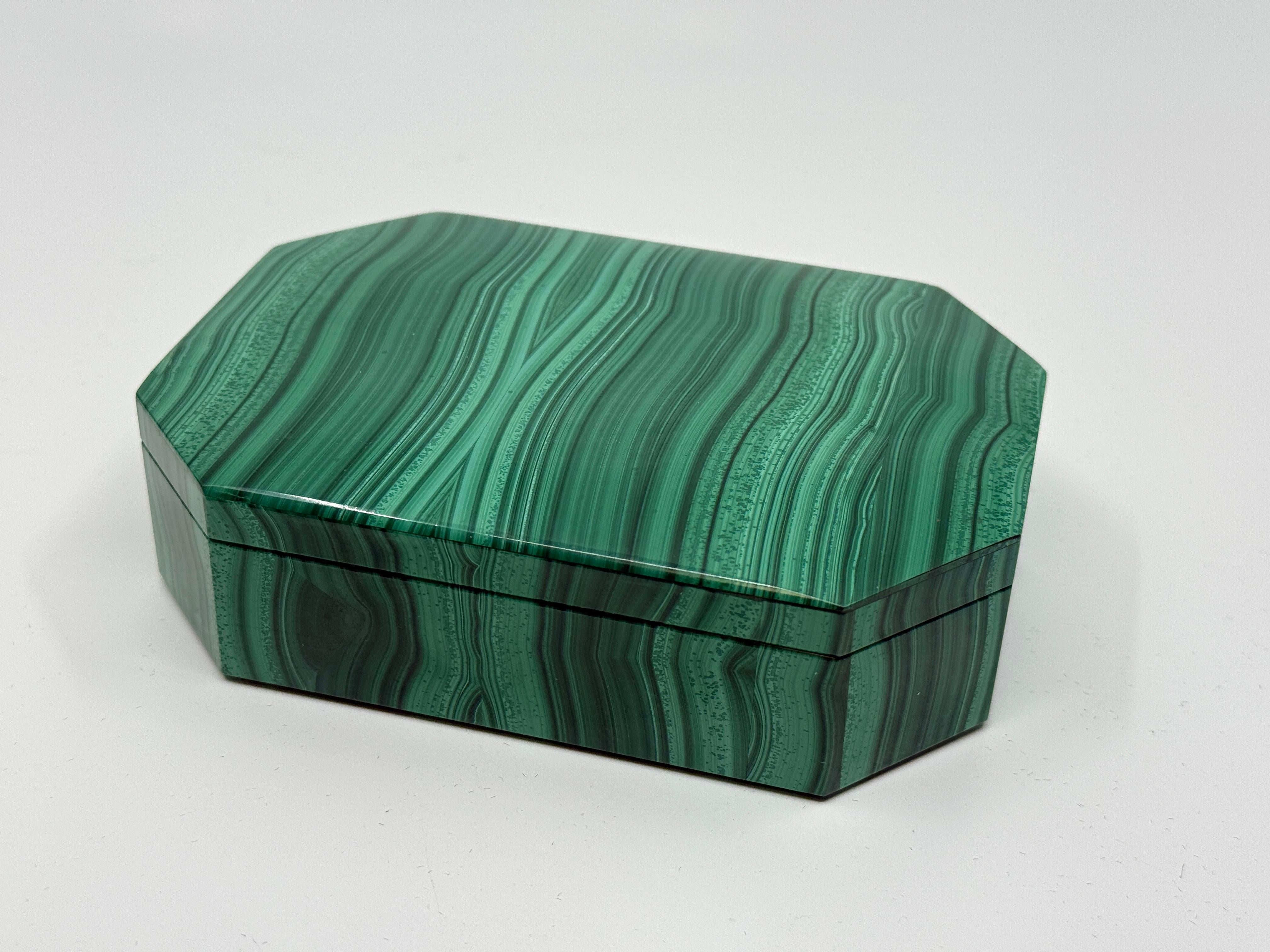 A beautiful dresser or trinket box veneered in stunning Malachite. The interior is lined in black marble or polished slate. The brass hinge is etched Asprey and has a serial number. Not sure if this is indeed an Asprey retailed item but it is a