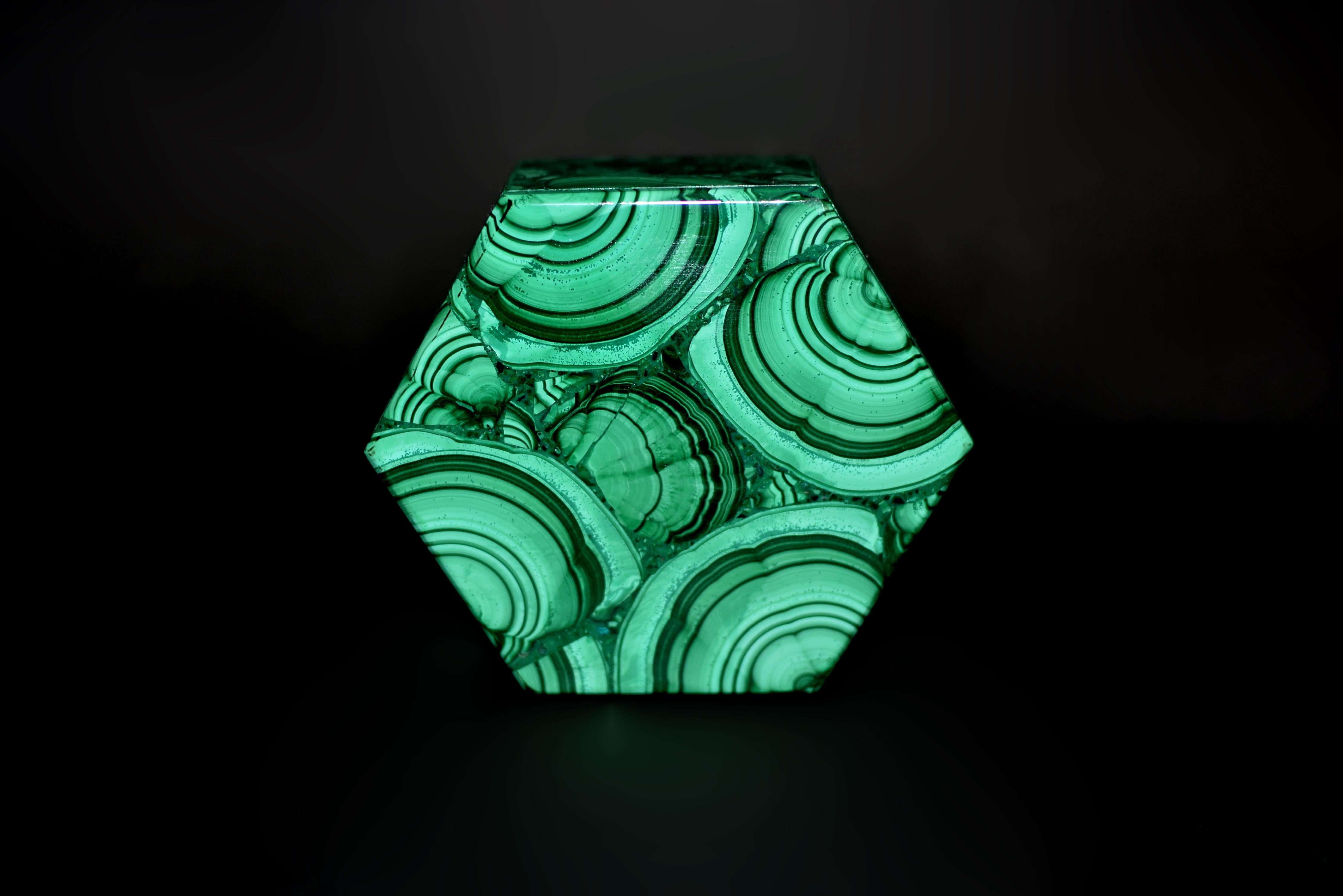 
This extraordinary fine-grade malachite hexagonal box showcases the coveted turkey tail pattern, a rare and highly prized formation within the stone. Malachite, renowned for its captivating spectrum of green hues, is most prized when it displays
