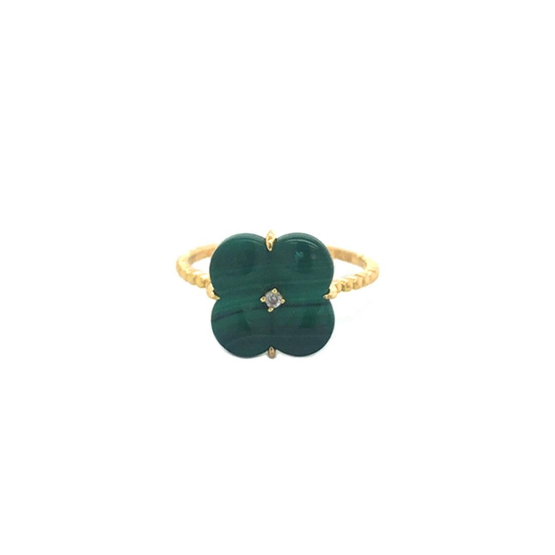 18K yellow gold malachite clover design diamond ring is an exquisite piece of jewelry that seamlessly blends elegance with a touch of whimsy.
Crafted from high-quality 18-karat yellow gold, the ring showcases a delicate clover design adorned with a