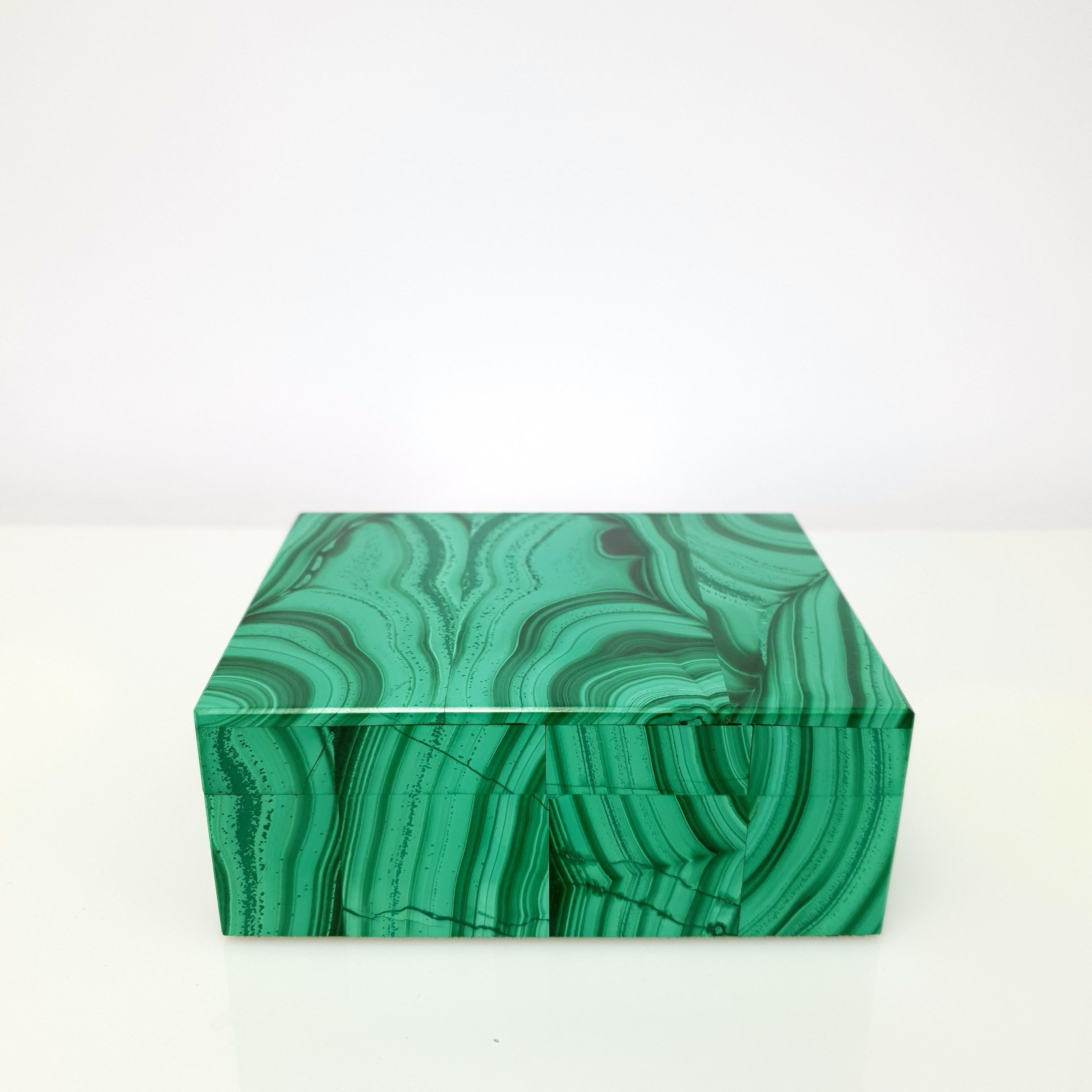 A Natural Handmade Malachite Decorative Jewelry Box.
The pattern looks like an artful painting of nature. The banding very fine.
The Inlay is made out of natural black Marble.
It's a great piece for decoration on a desk, vanity, or even as a special