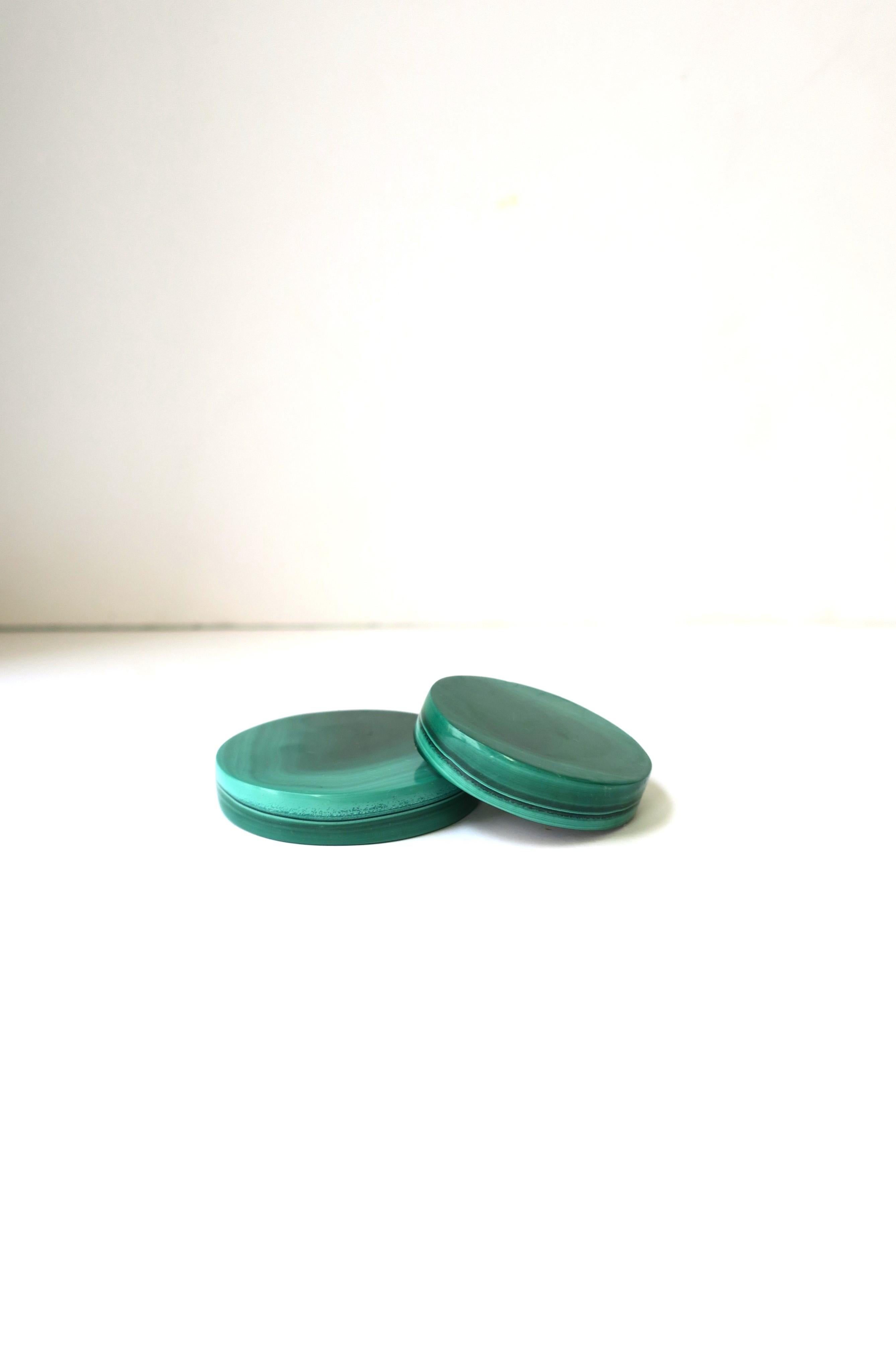 A beautiful set of two (2) round natural green malachite decorative objects. Pieces have a nice weight to them, round in shape, and polished smooth. Great items for a desk, cocktail table, display, etc. 

Dimensions: 
2.25