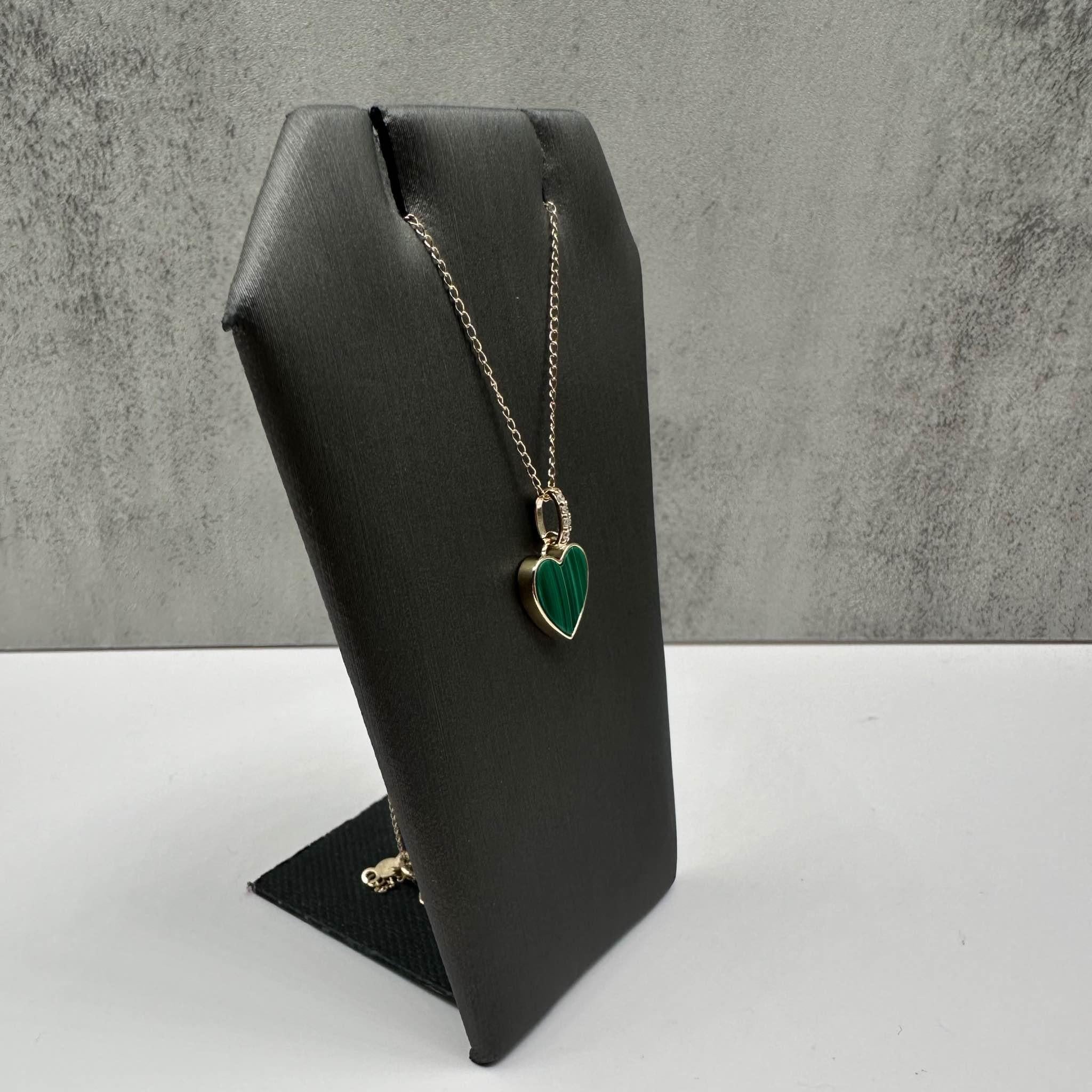 This elegant Malachite and Diamond Heart Necklace in 14kt yellow gold features a heart-shaped malachite stone, complemented by 0.03ctw of natural GH SI2-I1 round single-cut diamonds for added sparkle. The necklace is 18 inches in length, making it