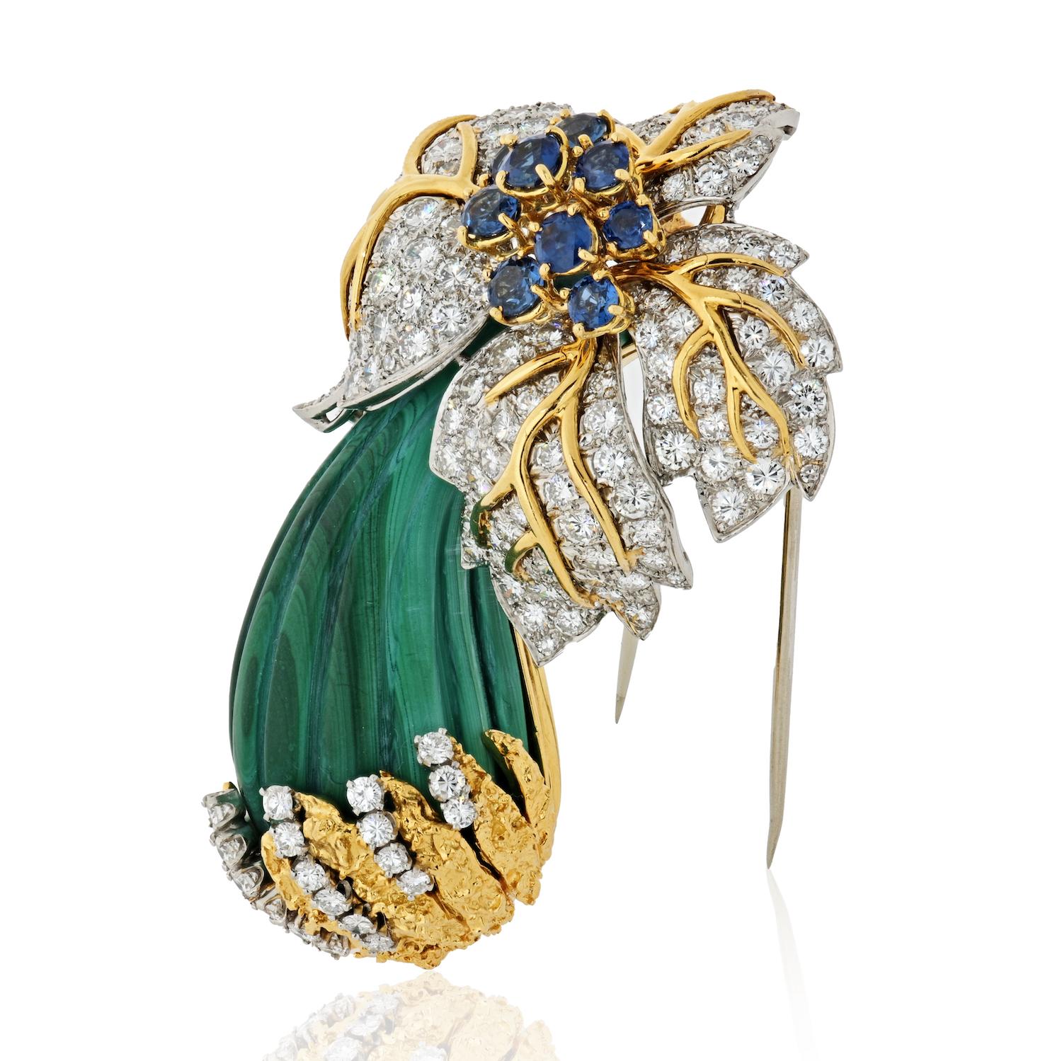 Unique nature inspired diamond and sapphire mushroom brooch. The top of the mushroom is pave set with round brilliant cut diamonds and 10 blue sapphires. 

The stem is made out of a green carved malachite finished by yellow gold grass and pave set
