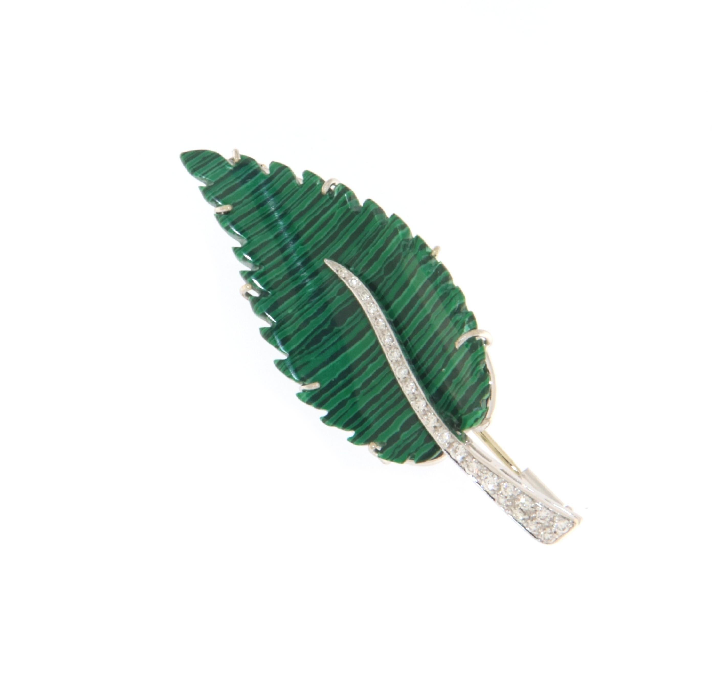 This exquisite brooch, crafted from 18-karat white gold and set with the striking beauty of malachite, offers a vivid portrayal of nature's artistry combined with luxurious elements. Shaped as a delicate leaf, the brooch captures the essence of