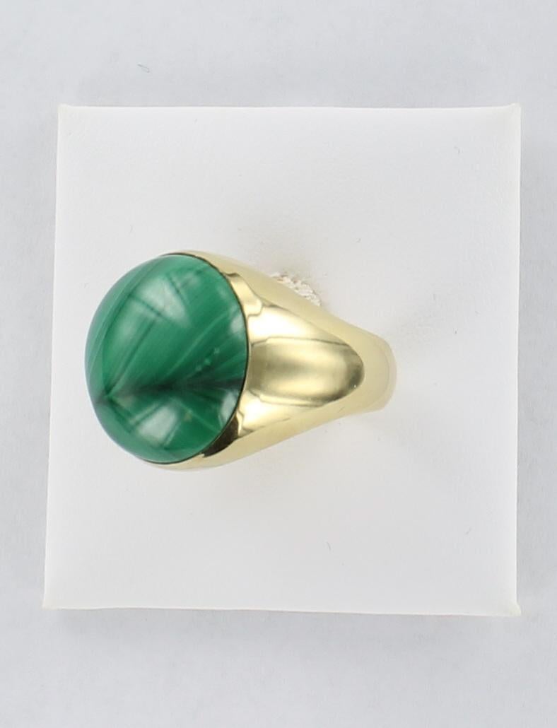 This is a very handsome 14 karat yellow gold ring show casing a gorgeous green malachite. The malachite is 3/4 inch wide and is set in a very substantial mounting. This is a fabulous ring for a man or a woman.