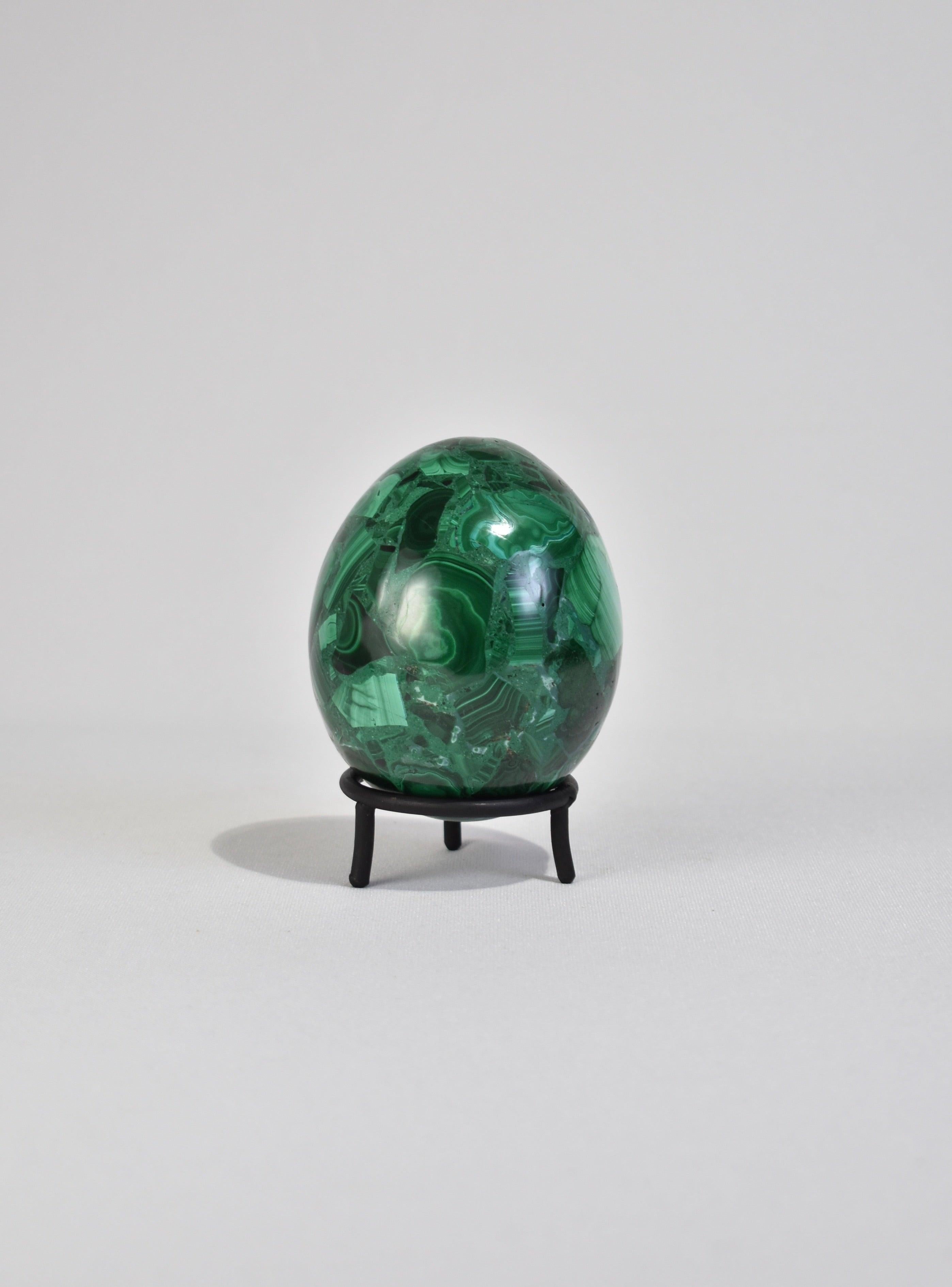 Vintage polished malachite egg sculpture with removable iron base.