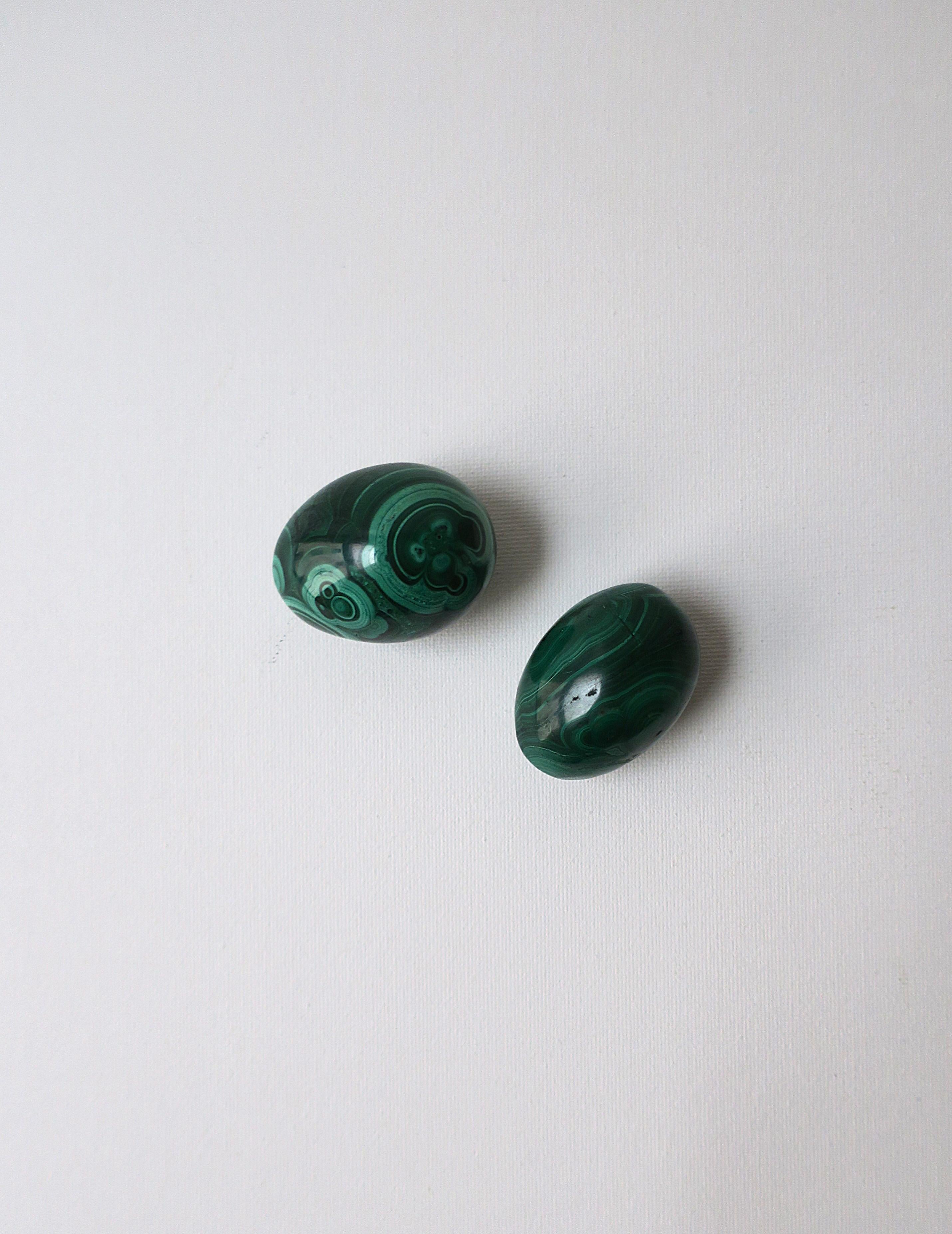 A beautiful set of two (2) green Malachite eggs decorative objects, circa 20th century. Malachite egg objects are hand-crafted and polished smooth. A beautiful set, exquisite decorative objects.

Dimensions:
1.25