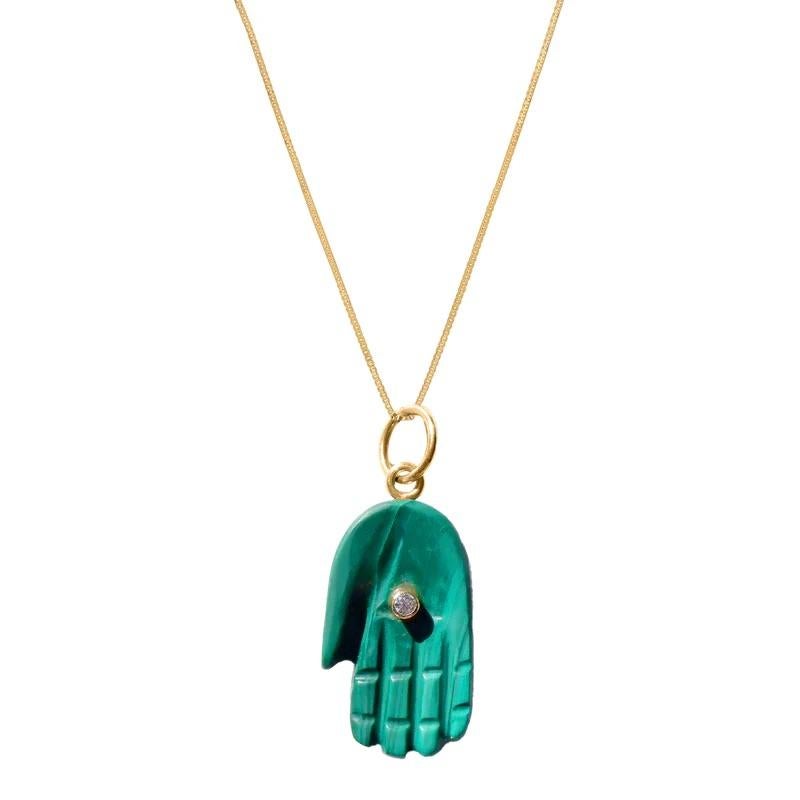 Malachite Diamond Gold Hamsa Pendant. Peace and Protection for all with the universal symbol of the Hamsa featuring a pendant in luminous natural green malachite with a center gold encased diamond 'eye’.

- Green Malachite apprx 35 carats.
- Set
