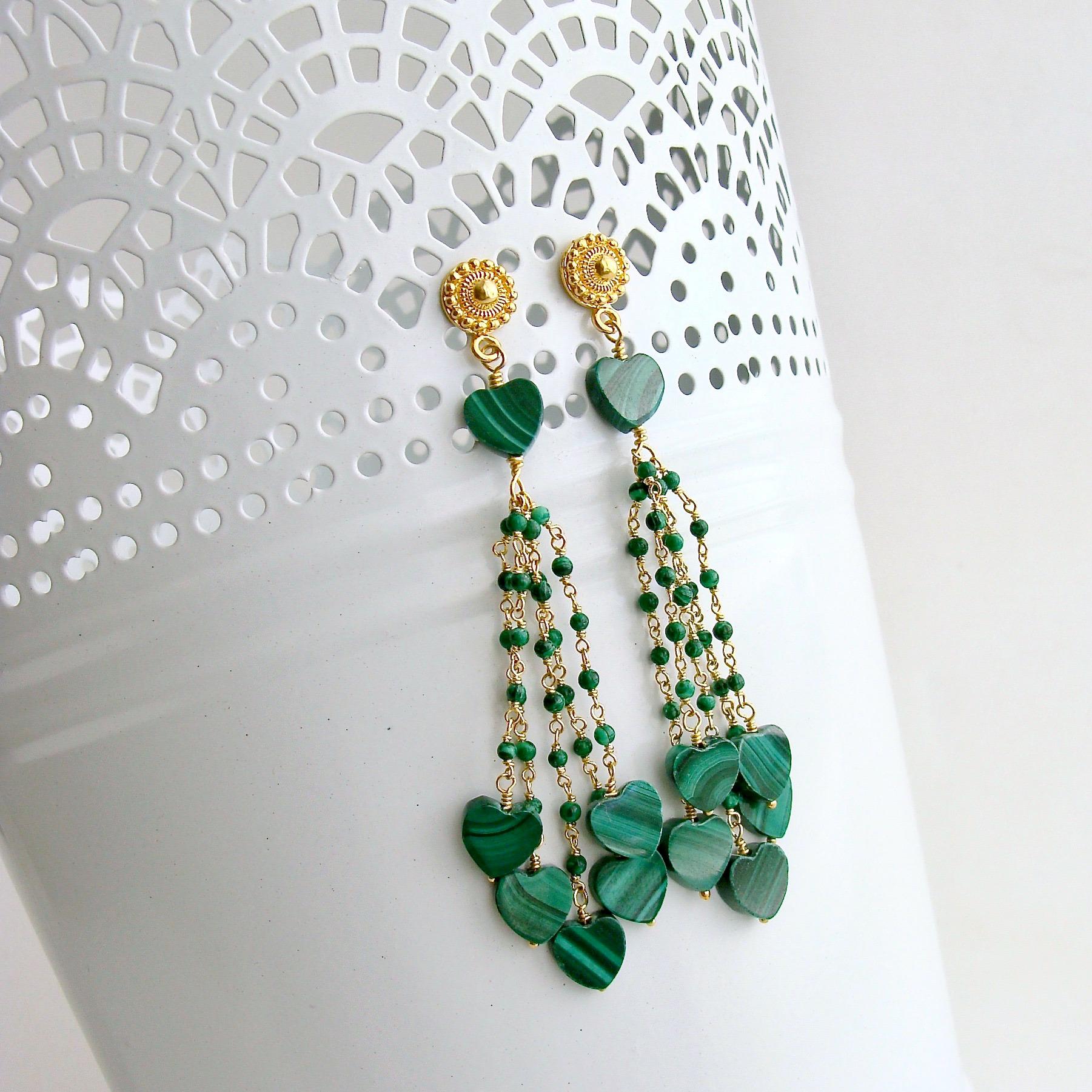 A jaw-dropping grouping of festive green malachite heart shaped beads have tumbled down from minuscule hand-linked malachite beads in gold vermeil to create these Bohemian style duster tassel earrings.  The graceful movement of the malachite within