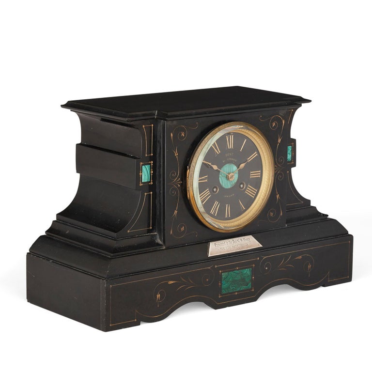 Malachite inlaid black marble plinth-form mantel clock
French, circa 1876
Measures: Height 24cm, width 39cm, depth 16cm

This rather unusual but nonetheless beautiful mantel clock is formed from deep black marble and green malachite, both of
