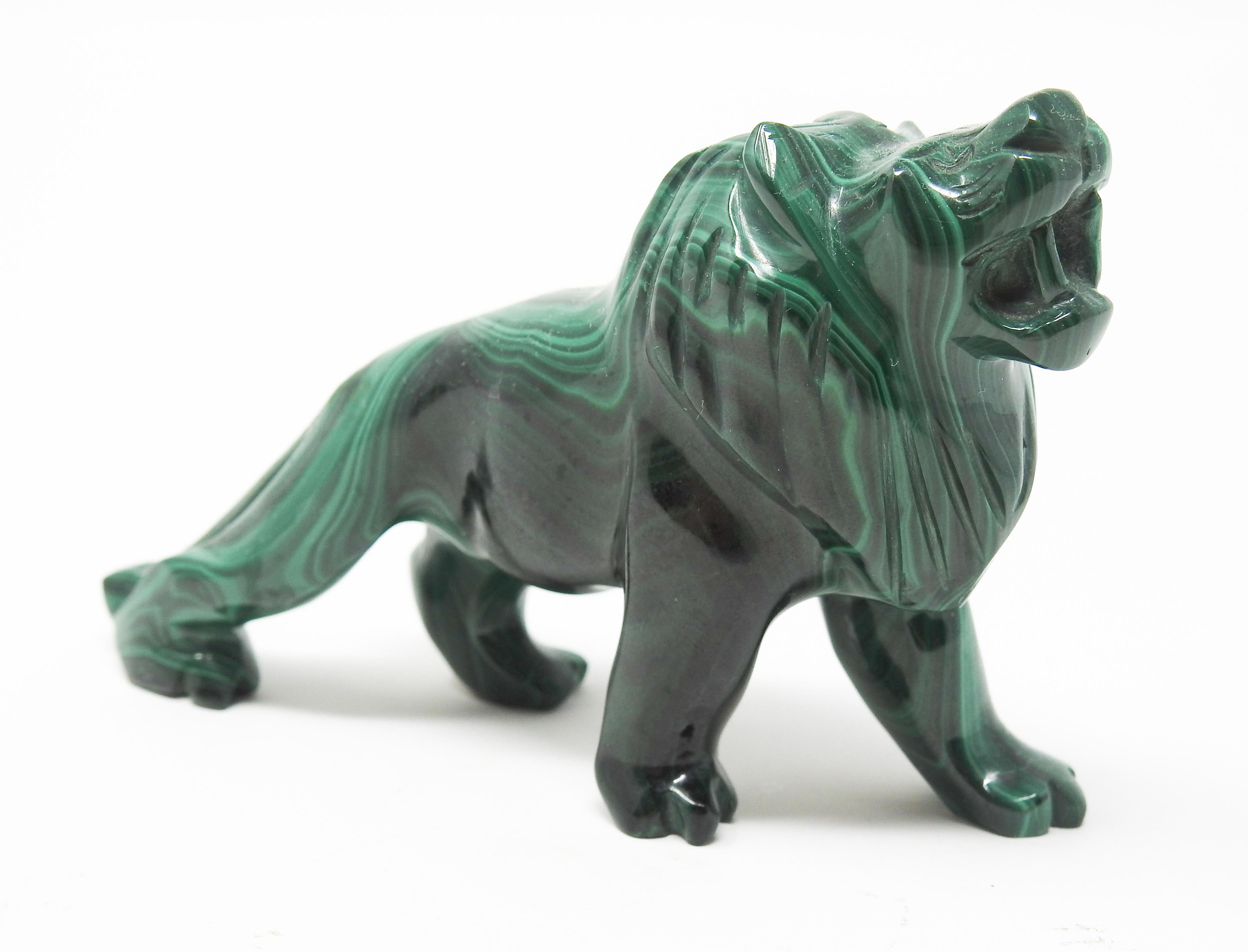Offering this gorgeous hand carved malachite lion. This lion is sculpted in a stretched out position and looks as if he is letting out a big roar. The beautiful natural lines in the stone make for a beautiful piece that many will talk about.