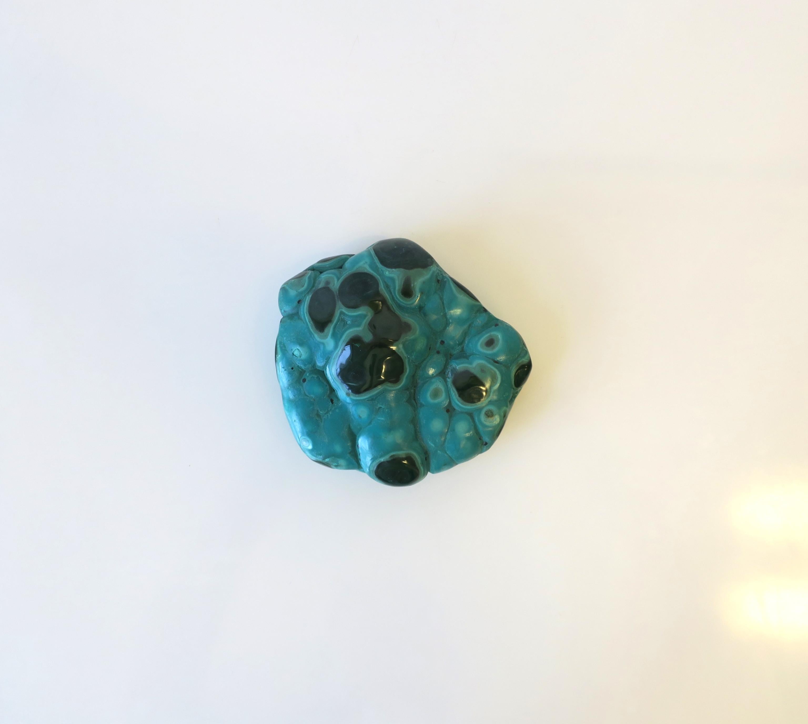 A substantial piece of natural green malachite, polished smooth. A great paperweight or decorative object (as demonstrated) for a desk, shelf, table, etc. Dimensions: 4.5