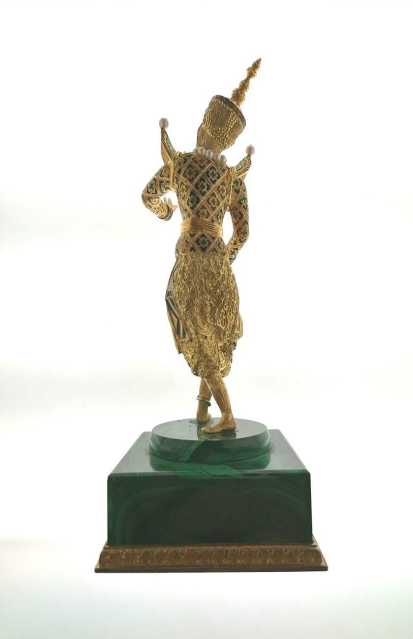  Malaysian dancer sculpture in 18k yellow gold  with enamels in different colors. It has small pearls on the shoulders, the neck and as a belt. The base is in Malachite. The total weight with the base is 552 grams. The sculpture without base we
