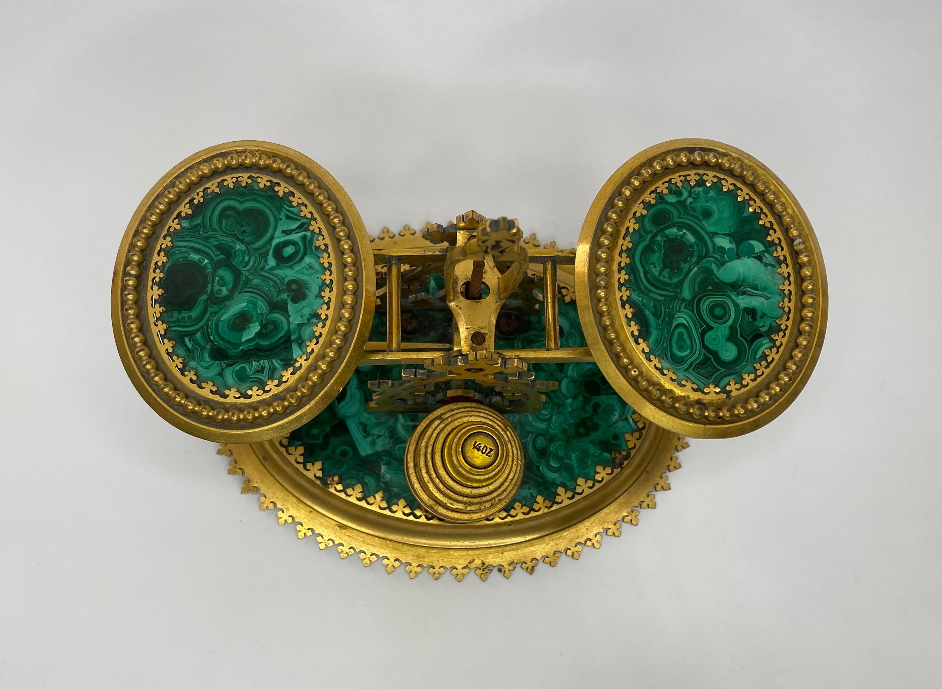 A fine and rare set of malachite and gilt metal postal scales, Halstaff and Hannaford, 228, Regent Street, London, c. 1850. The Gothic form scales, set upon an oval base, of solid malachite, with gilt metal mounts.
Original set of graduated, gilded