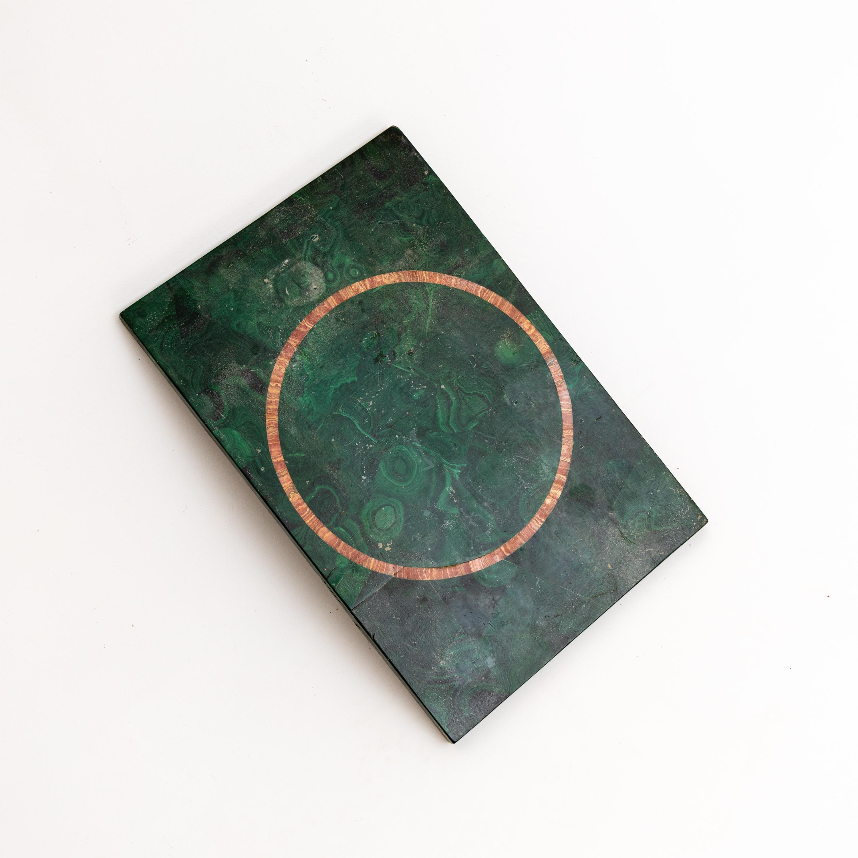 Malachite veneered onto a rectangular stone slab with a ring-shaped inlay of agate. Breakage, old restored.