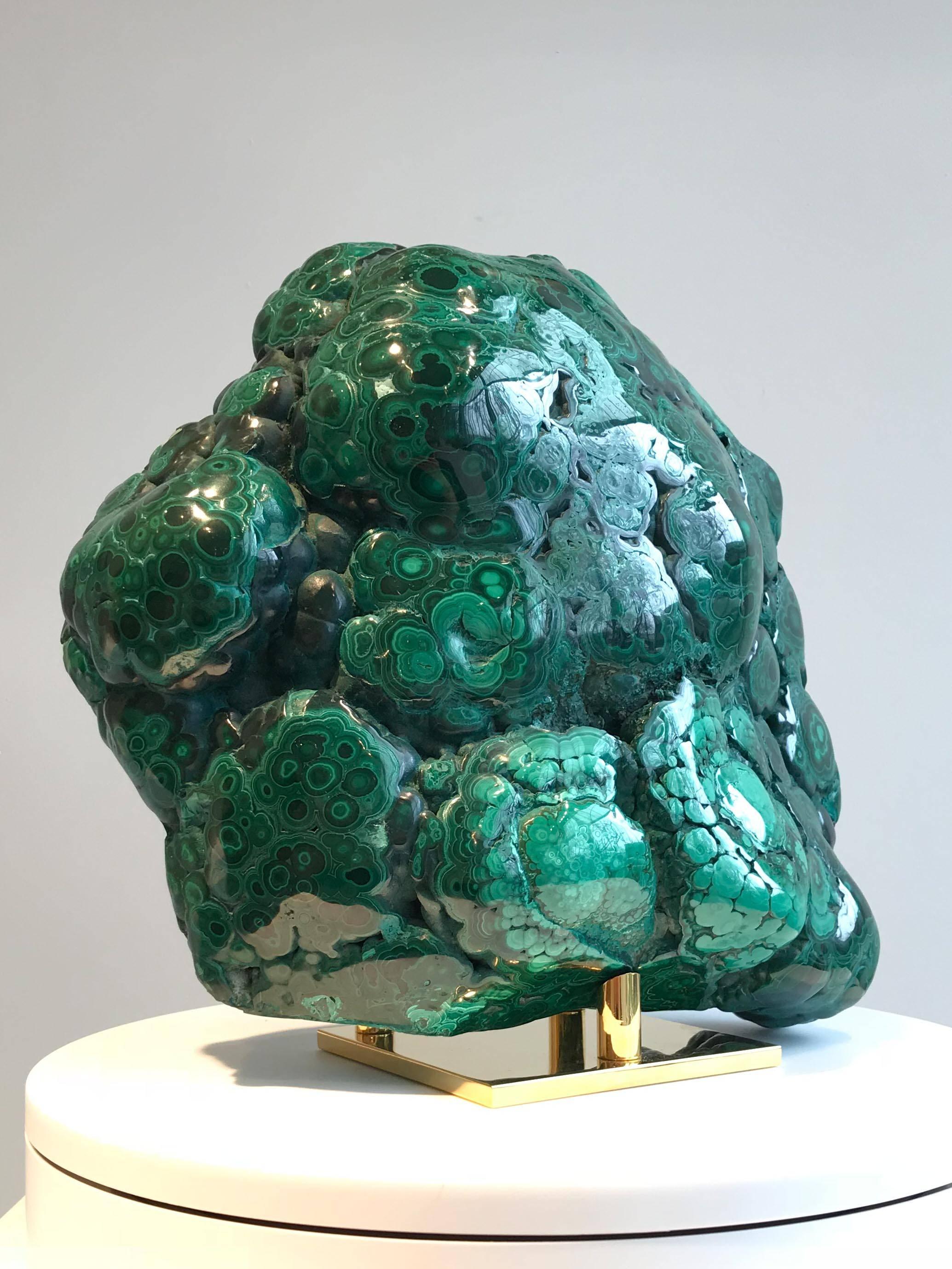 Large natural malachite specimen on 14-karat gold-plated stand.