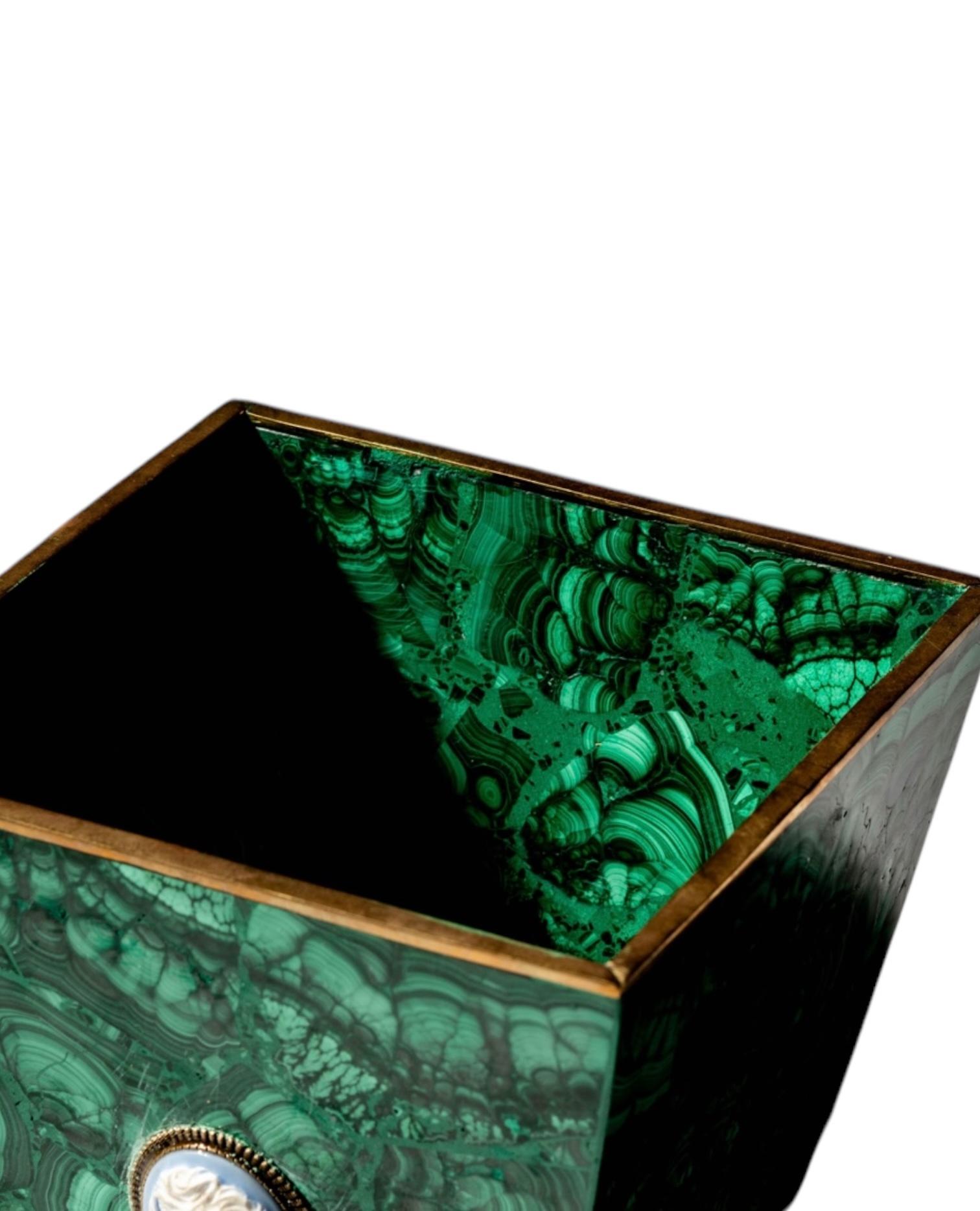 Add a touch of luxury and elegance to your space with this Malachite Square Planter. Crafted from exquisite malachite, this planter showcase the stone’s signature rich green hues and mesmerizing natural patterns, making it a striking statement piece