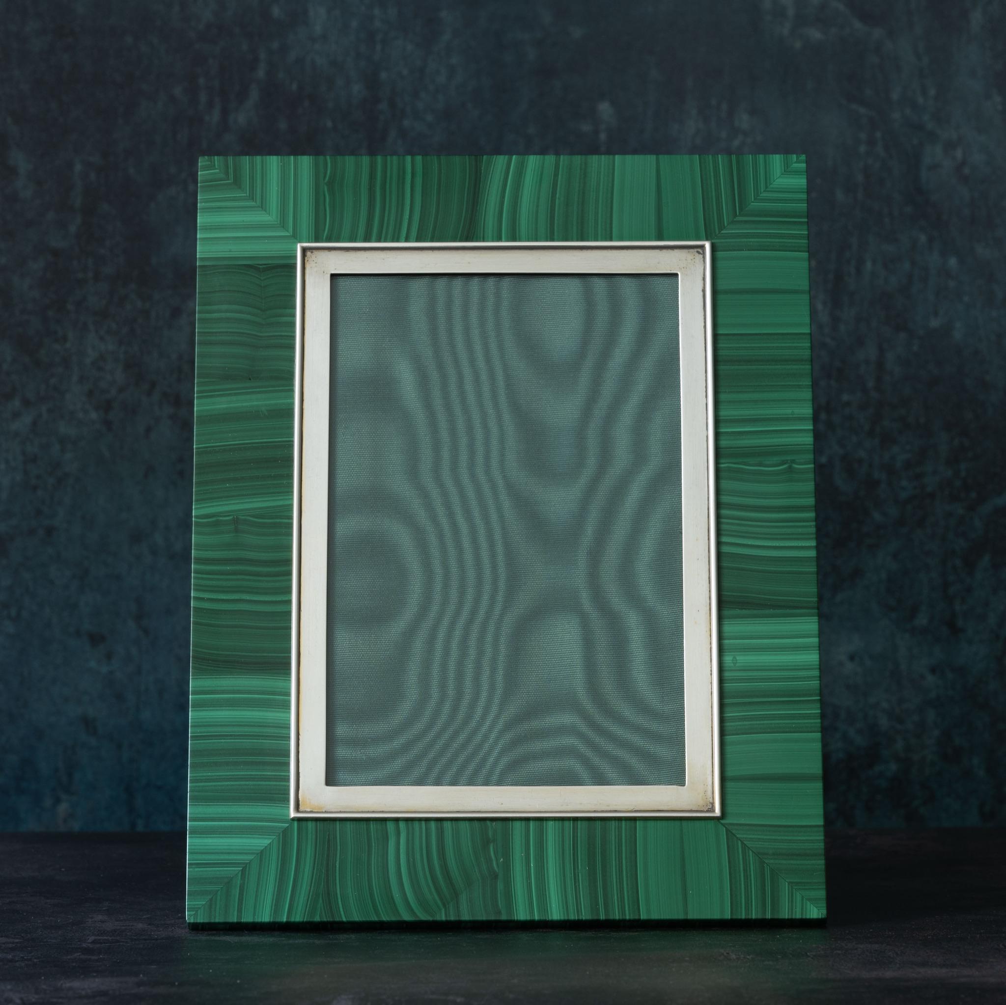 Beautiful silver mounted malachite picture frame made in Florence, Italy, circa 1970. Has original velvet covered back with a supporting foot designed so the frame can sit in either portrait or landscape format. 

Dimensions: 21.3cm/ 8⅜