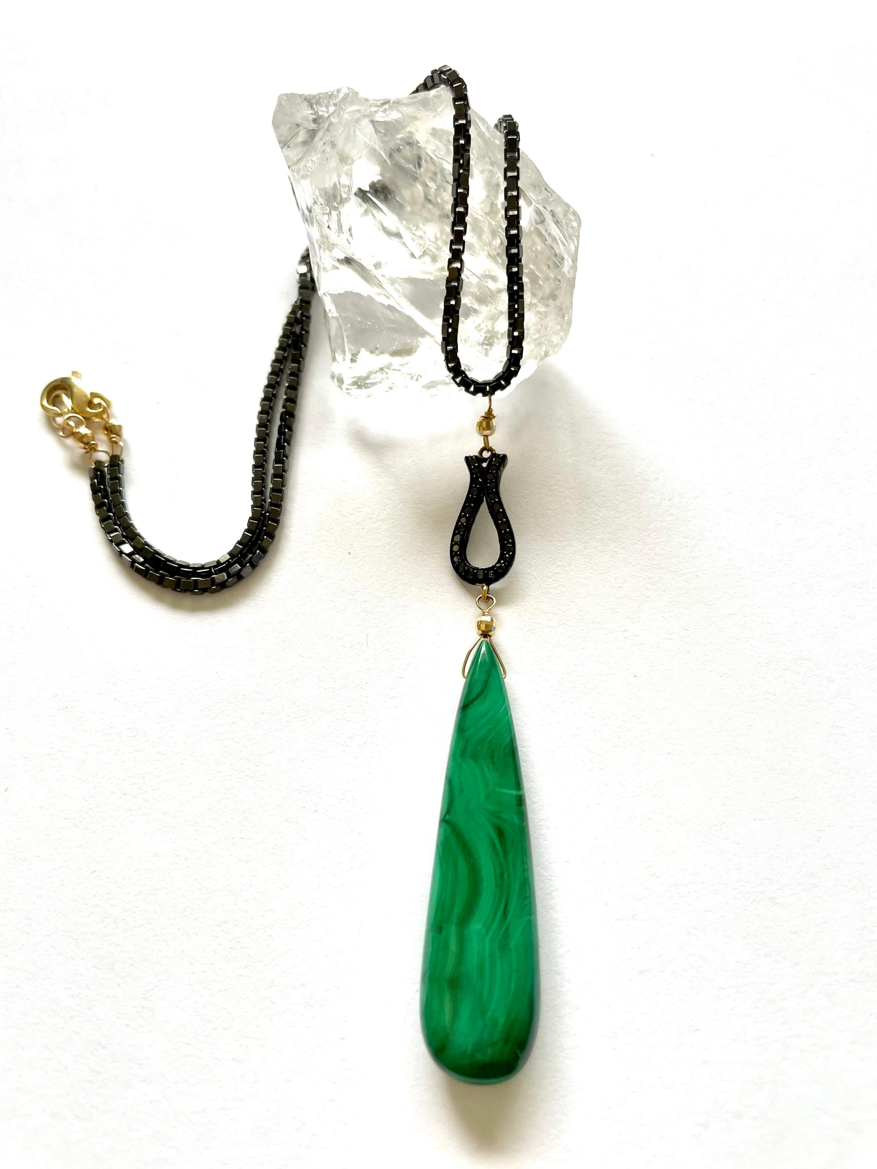 Description
Casual and striking Malachite with black pave diamonds and black chain necklace highlighted with 14k yellow gold accents.  
Item # N3696

Materials and Weight
Malachite, 13 x 50mm, elongated drop shape, 42 carats.
Black pave diamonds.
