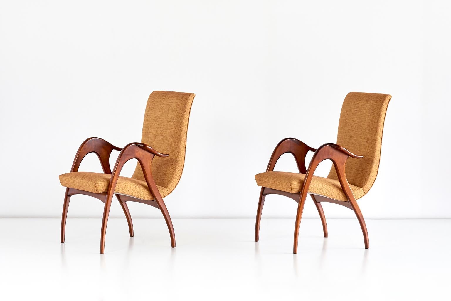 These sculptural armchairs were produced by Malatesta and Mason in Rome in the early 1950s. The elegant, organically shaped frames are complemented by the dynamically flowing line of the seat. The legs and armrests are characterized by the warm