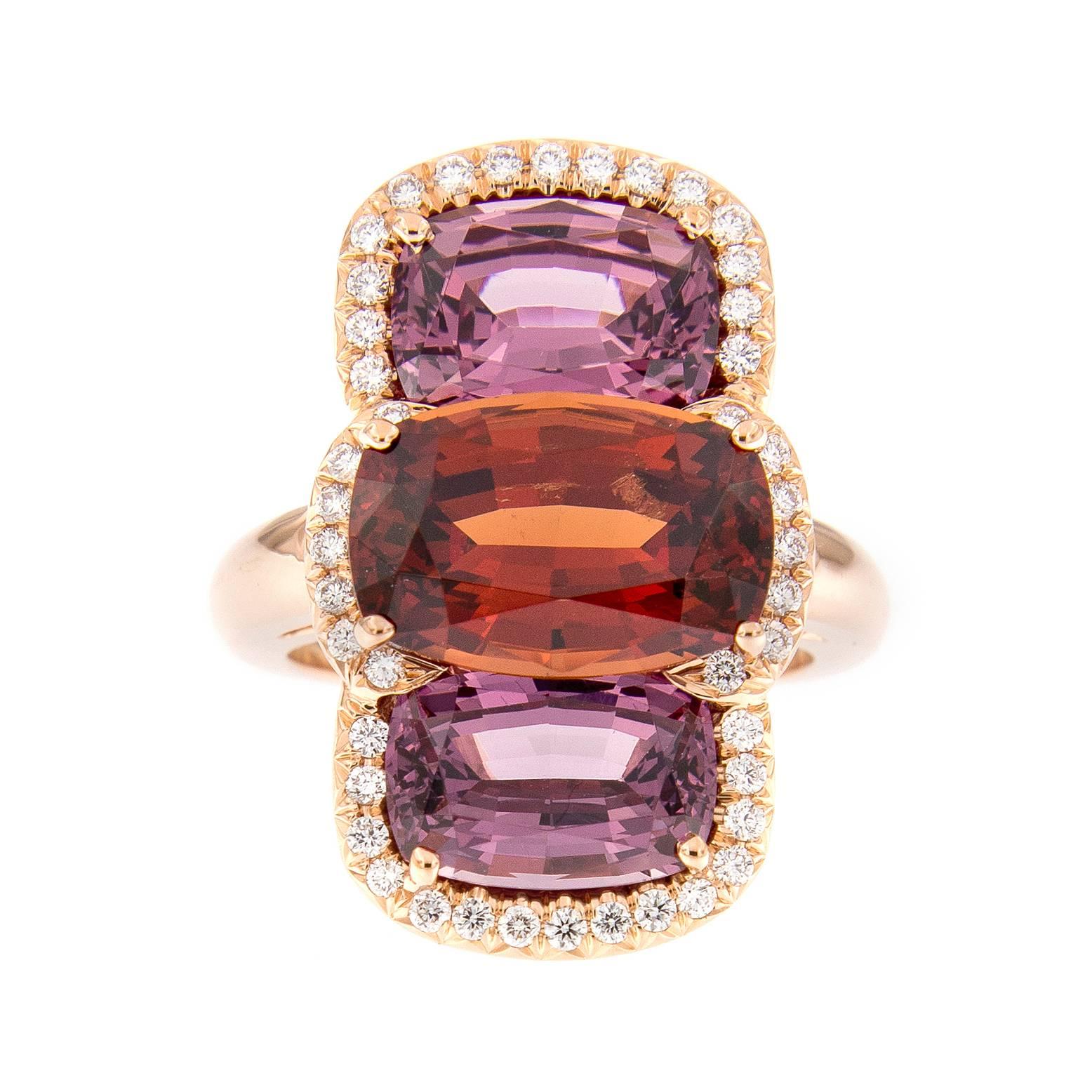 Beautiful color combination of a Lindi garnet and two Malaya garnets, one of the rarer and more interesting ‘hybrid’ varieties of garnet. Accented with sparkling white diamonds all beautifully set in 18k rose gold. Handcrafted in New York. Ring Size